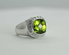 This is a 14 Karat Gold Natural Peridot with a Halo or Brilliant Round Diamonds