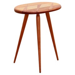 This is a beautiful side table on slender legs made in the 1960s.