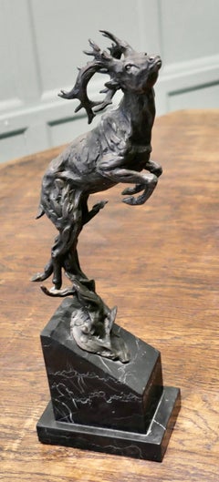This is a Signed Bronze Sculpture of a Deer Jumping, Mounted on a Marble Plinth