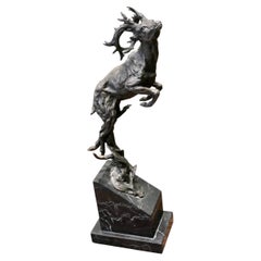 This is a Signed Bronze Sculpture of a Deer Jumping, Mounted on a Marble Plinth