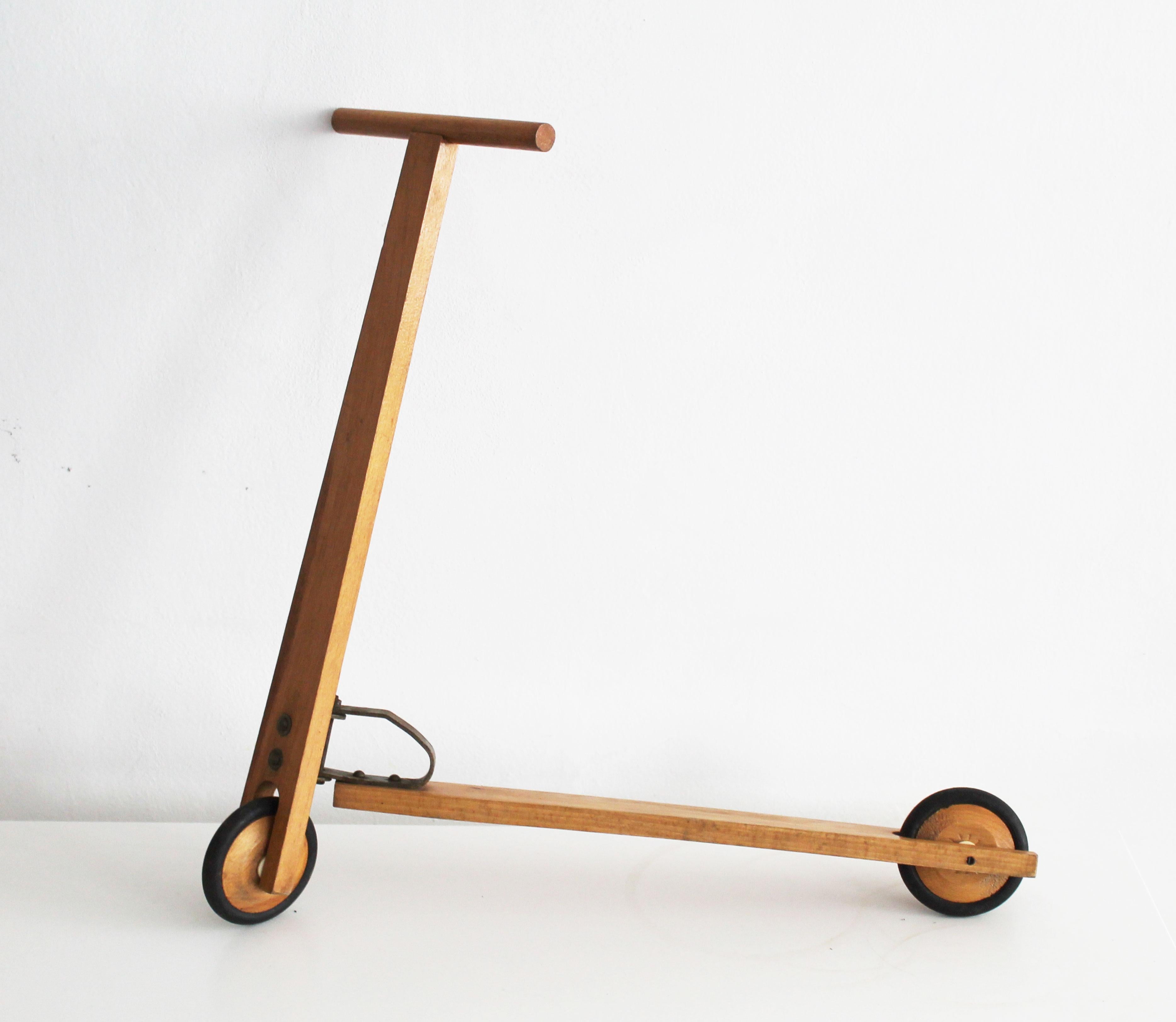 This is an original wooden scooter for kids believed to be made in 1950's in Czechoslovakia.

This piece has a lovely design and can still work perfectly as a vintage kids scooter or simply as home decor. The beauty of this scooter is both in the