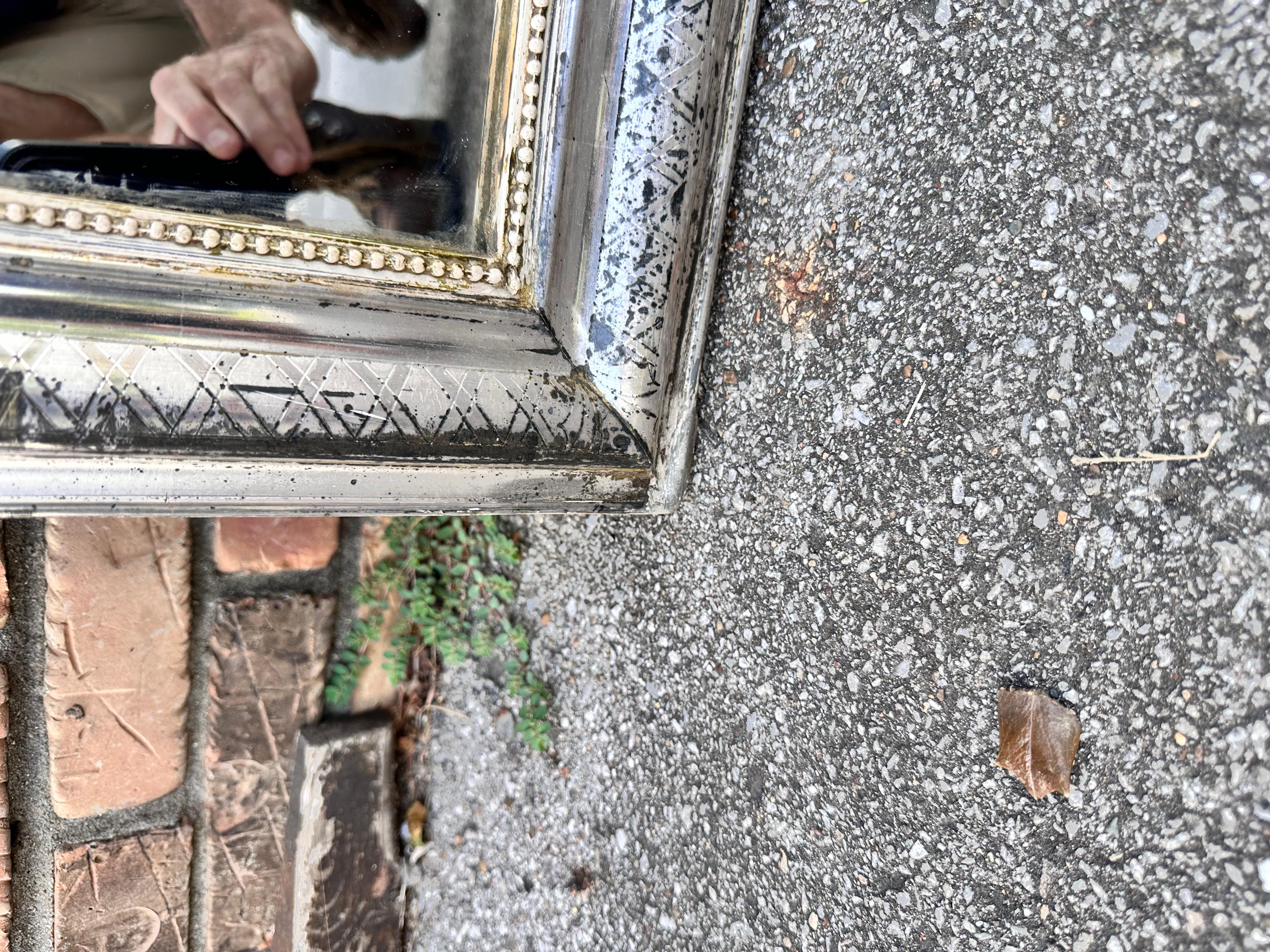 This is a gorgeous 19th century Louis Philippe Mirror! There is hand carved detail on the edges of the mirror in a simple but pretty style. Silver mirrors are harder to come by in this style making finds like this one special. This mirror has aged