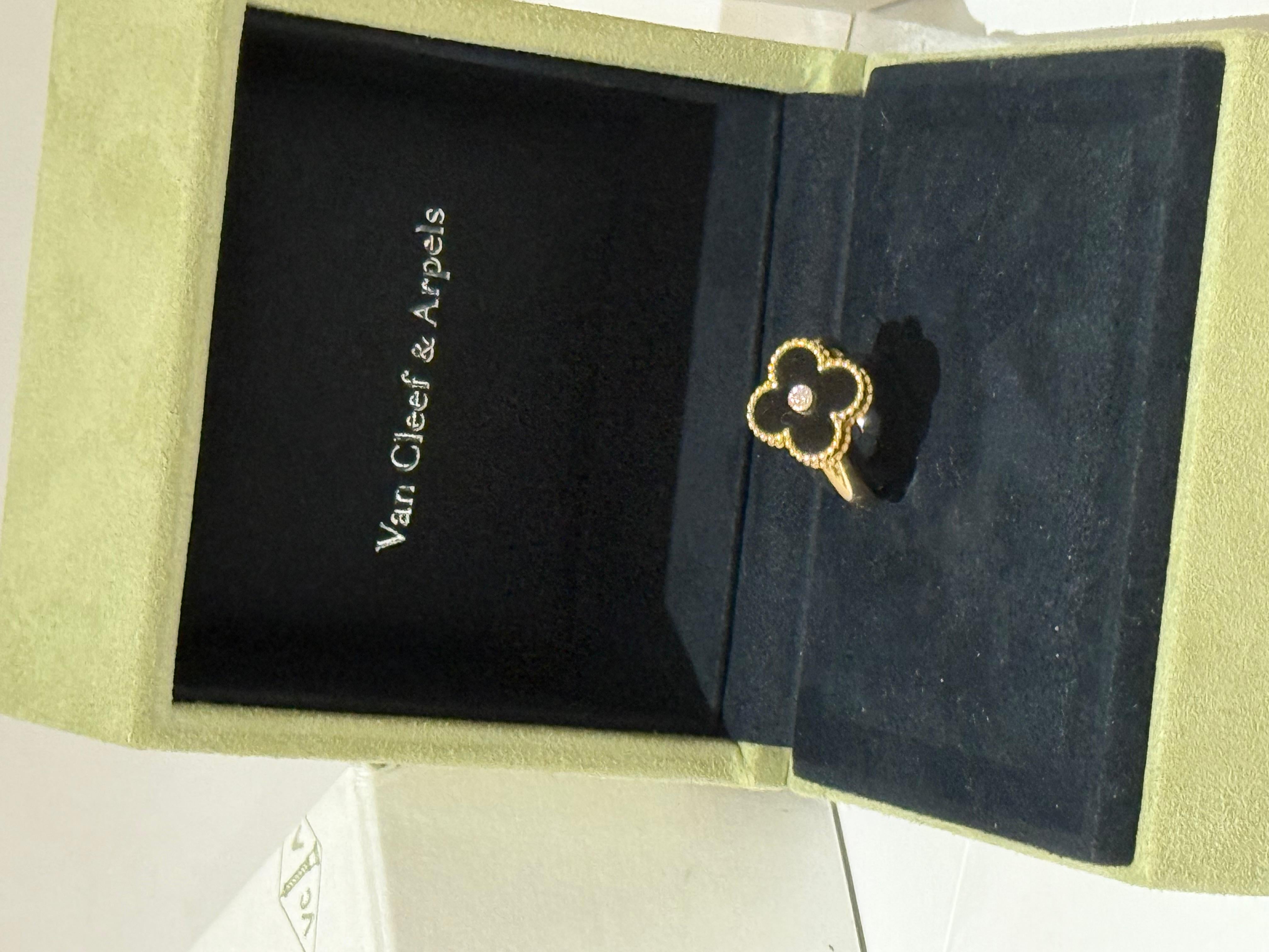This Van Cleef & Arpels Vintage Alhambra Ring is crafted from 18K gold, onyx and diamond and features a band design. 
Signature 