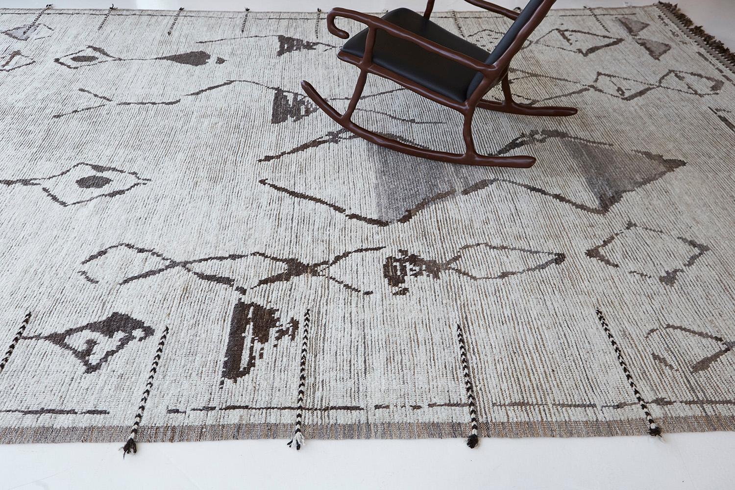 A gorgeous rug that features the symbolism of ancient woven art that is reminiscent of tribal essence. Boasting an all-over ambiguous tribal element composed of the eye, lozenges, and male motifs. This depth of meaning presented in a bold and