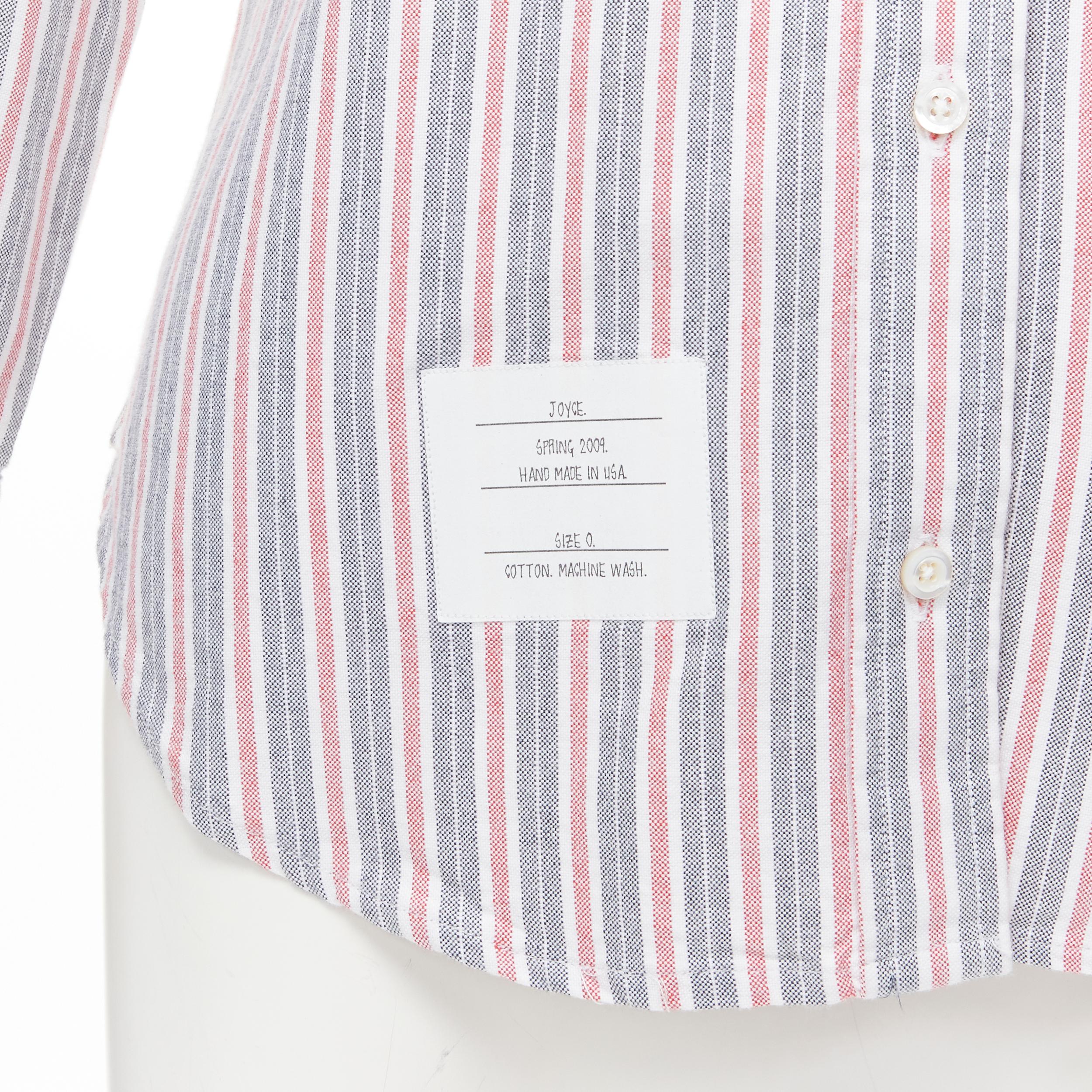 THOM BROWNE 2009 Signature grey red stripe cotton slim fit shirt US0 
Reference: MELK/A00119 
Brand: Thom Browne 
Collection: Spring 2009 
Material: Cotton 
Color: Grey 
Pattern: Striped 
Closure: Button 
Extra Detail: Button collar. Curved hem.