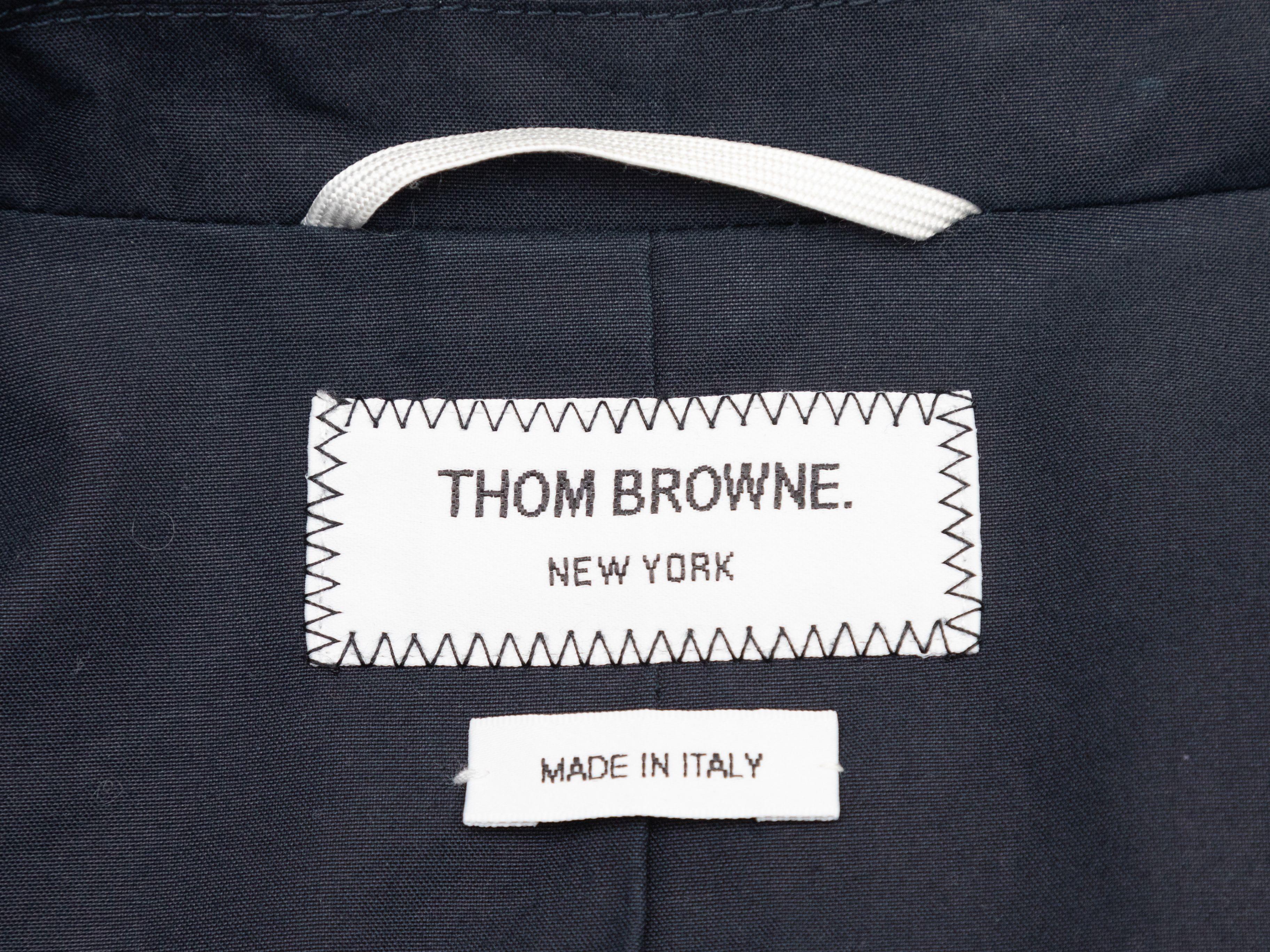 Product Details: Navy hooded cotton blazer by Thom Browne. Notched lapel. Three pockets. Button closures at center front. Designer size 2. 36