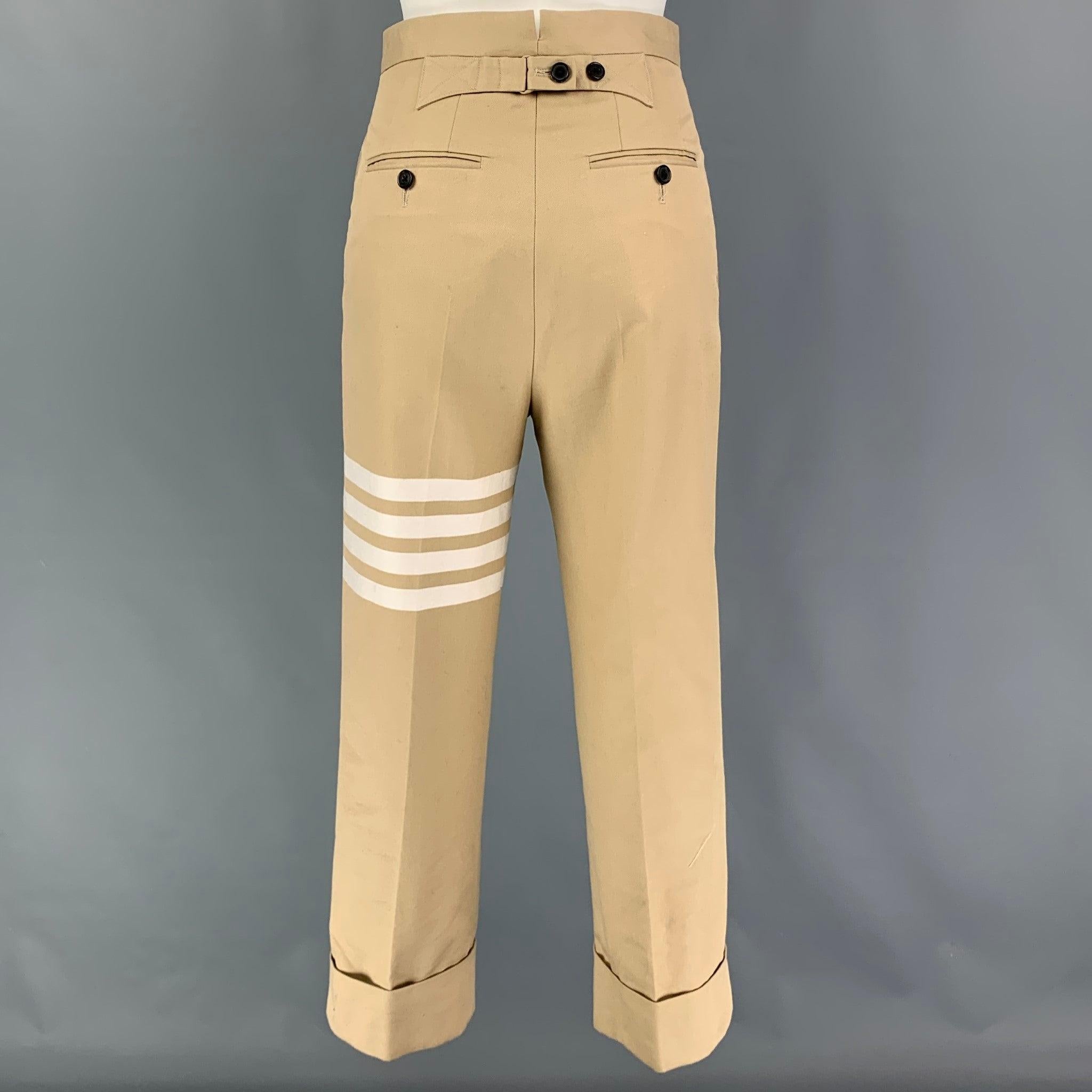 THOM BROWNE pants comes in a khaki cotton featuring a chine style, cuffed leg, striped detail, pleated, front tab, and a zip fly closure. Made in Italy. Very Good
 Pre-Owned Condition. 
 

 Marked:  36 
 

 Measurements: 
  Waist: 26 inches Rise: 13