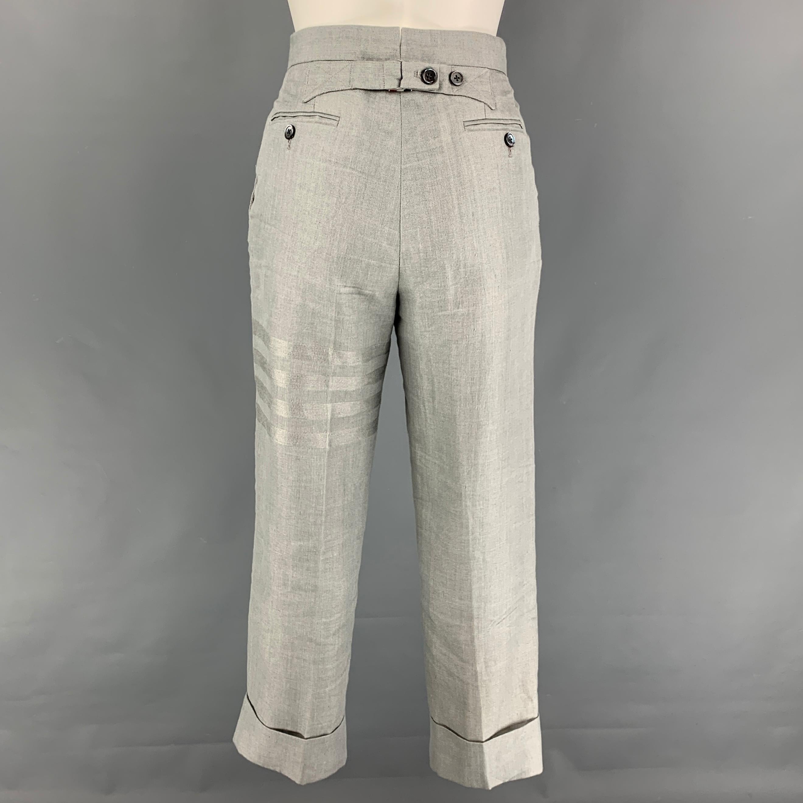 THOM BROWNE casual pants comes in a light gray linen featuring a high waist, cuffed leg, pleated, front tab, and a button fly closure. Made in Italy.

Very Good Pre-Owned Condition.
Marked: 36
Original Retail Price: $1,280.00

Measurements:

Waist: