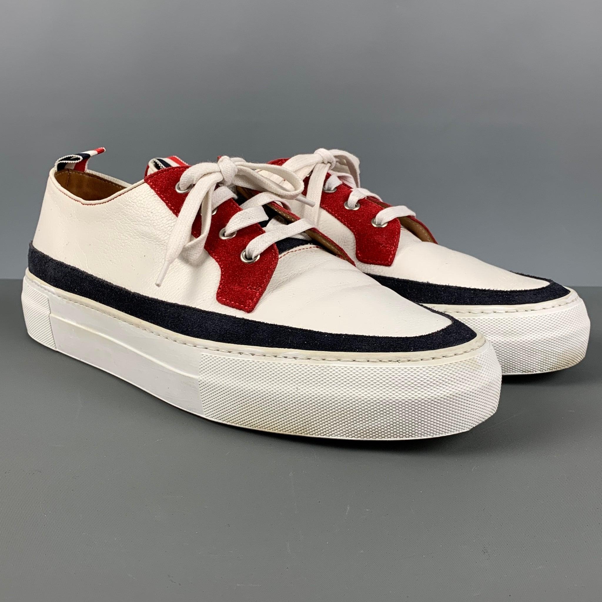 THOM BROWNE sneakers comes in a white leather featuring a navy and red suede details, low-top style, platform soles, and a lace up closure. Made in Italy.Very Good Pre-Owned Condition.  

Marked:   10Outsole: 12.5 inches  x 4.25 inches  
  
  
