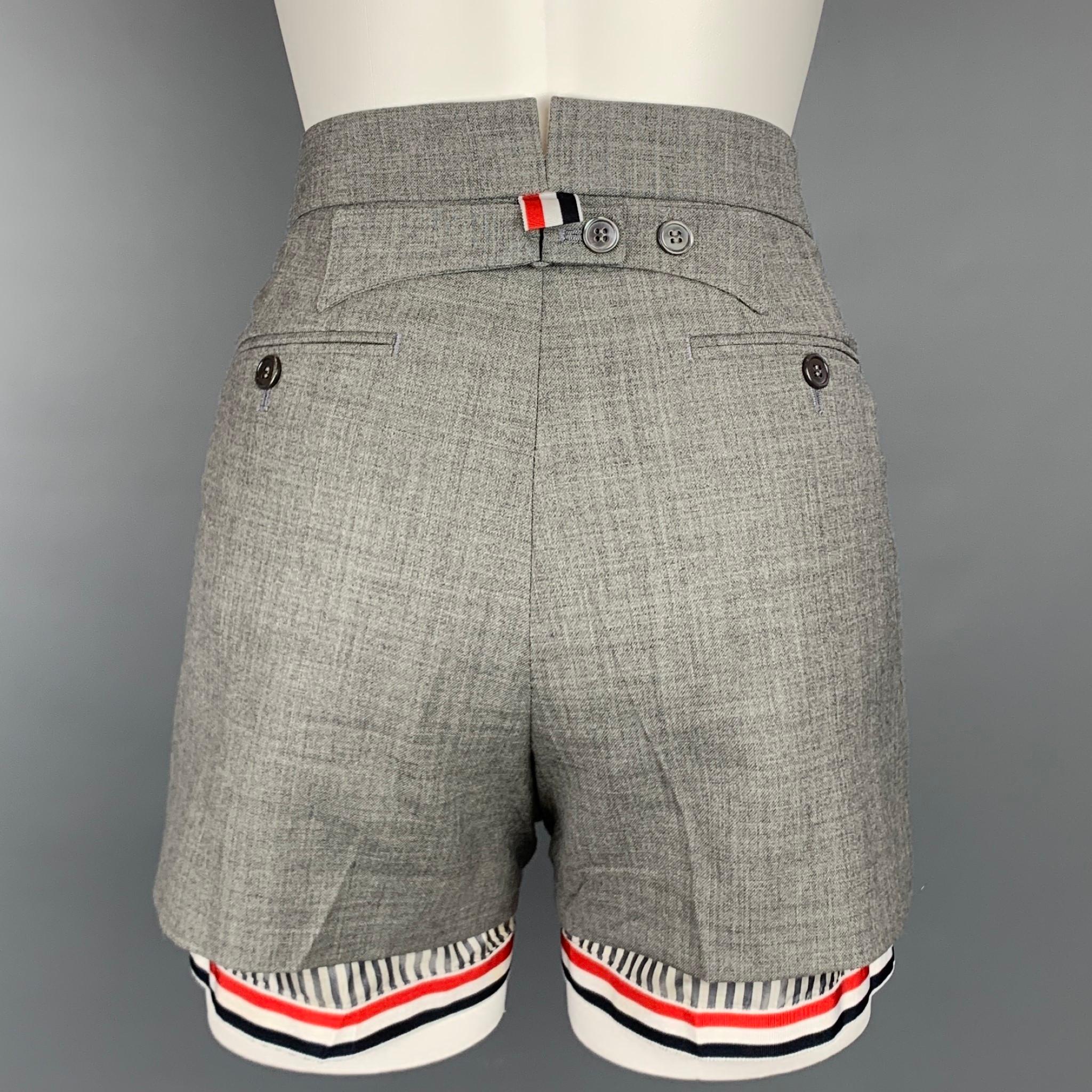 THOM BROWNE shorts comes in a grey & white wool featuring a striped lining design, back belt, pleated, front tab, and a zip fly closure. Made in Italy.

Very Good Pre-Owned Condition.
Marked: IT 38
Original Retail Price: