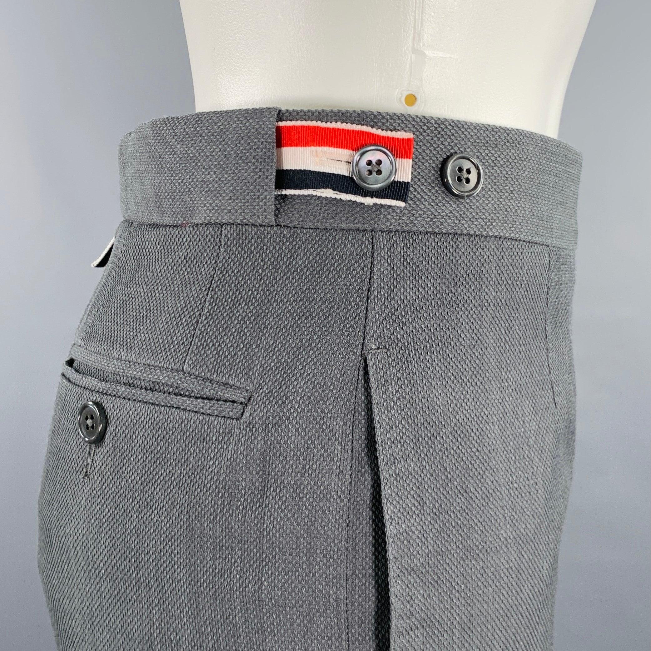 THOM BROWNE dress pants
in a
grey wool featuring a flat front style, narrow cuffed leg, and button fly closure. Made in Italy.Excellent Pre-Owned Condition. 

Marked:   38 

Measurements: 
  Waist: 27 inches Rise: 8.5 inches Inseam: 25 inches 
  
 