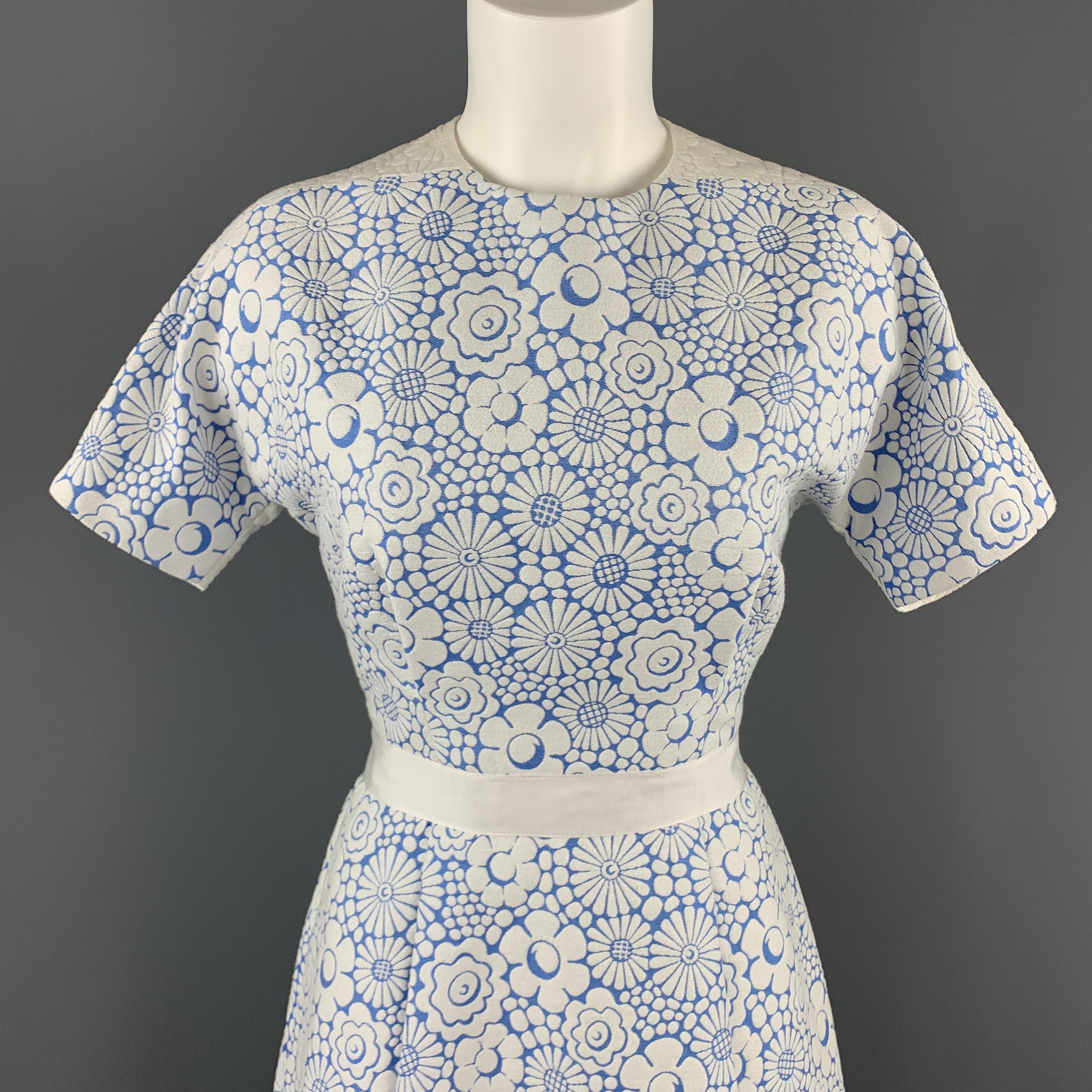 Lovely sheath dress by THOM BROWNE. A nod at a classic 1960's style in a textured floral cotton with structure, featuring a high neckline, short sleeve, ribbon piping, and pleated bodice and skirt with A-line shape. Made in USA.

Excellent Pre-Owned