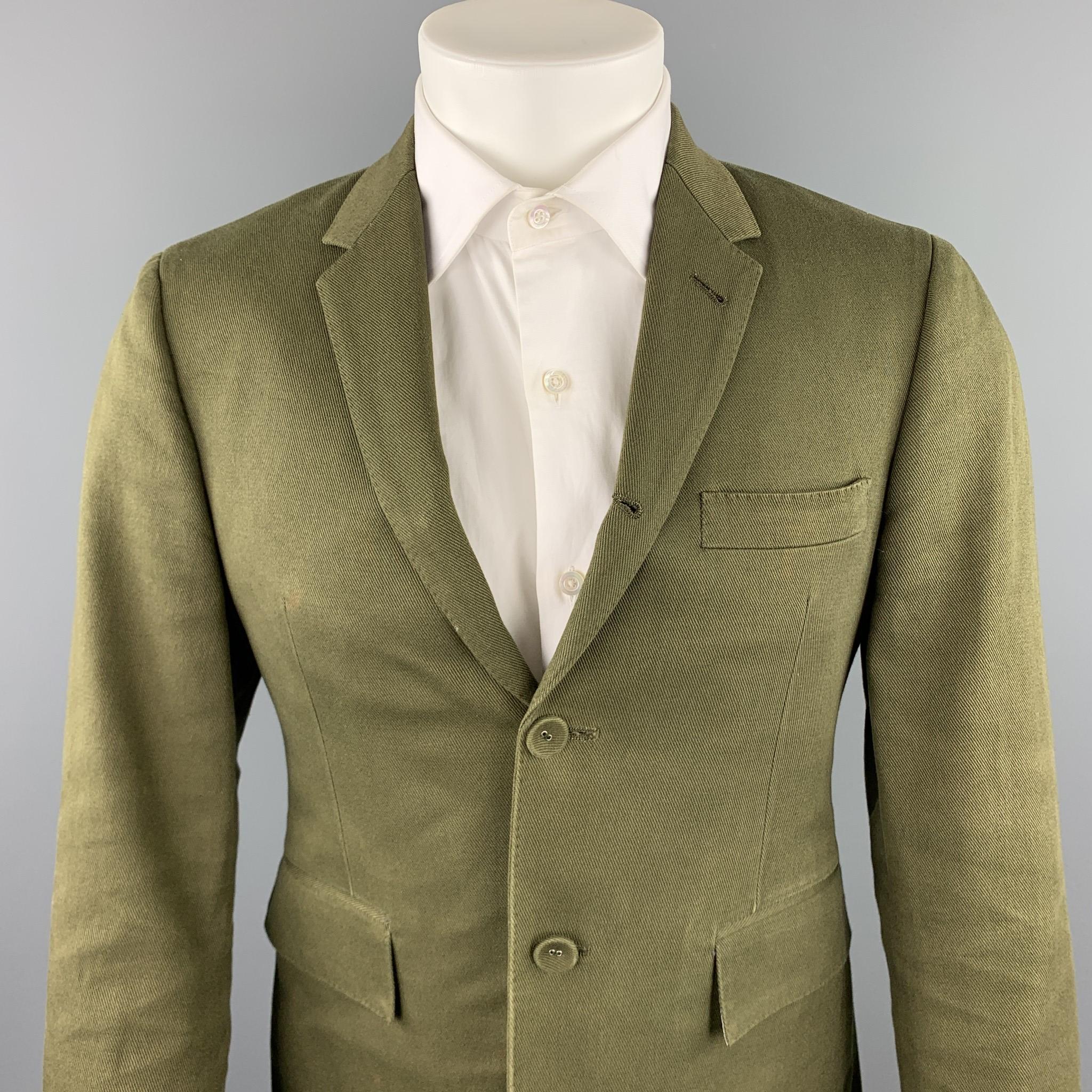 THOM BROWNE sport coat comes in a olive cotton with a full stripe liner featuring a notch lapel, flap pockets, and a two button closure. Minor discoloration. As-Is. Made in Japan.

Good Pre-Owned Condition.
Marked: 1

Measurements:

Shoulder: 17 in.