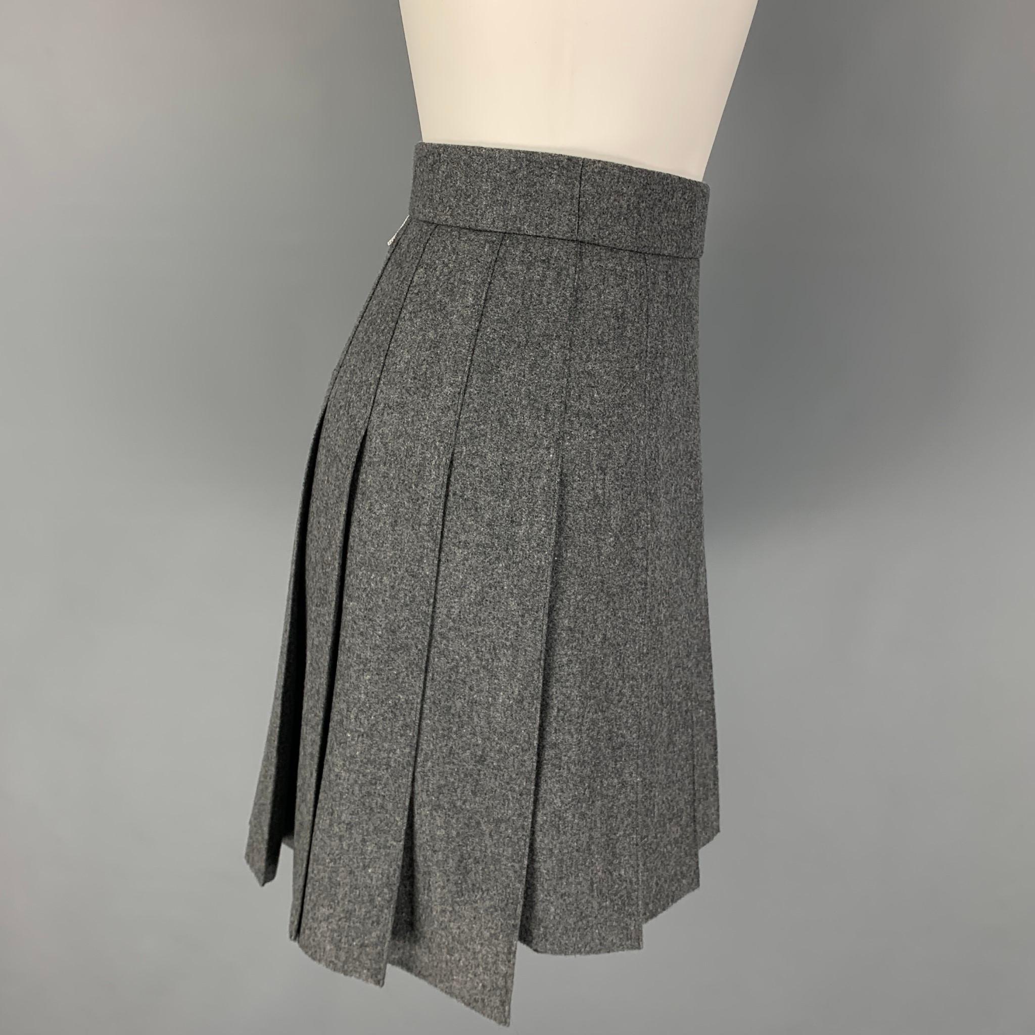 THOM BROWNE skirt comes in a grey wool / cashmere with a slip liner featuring a 