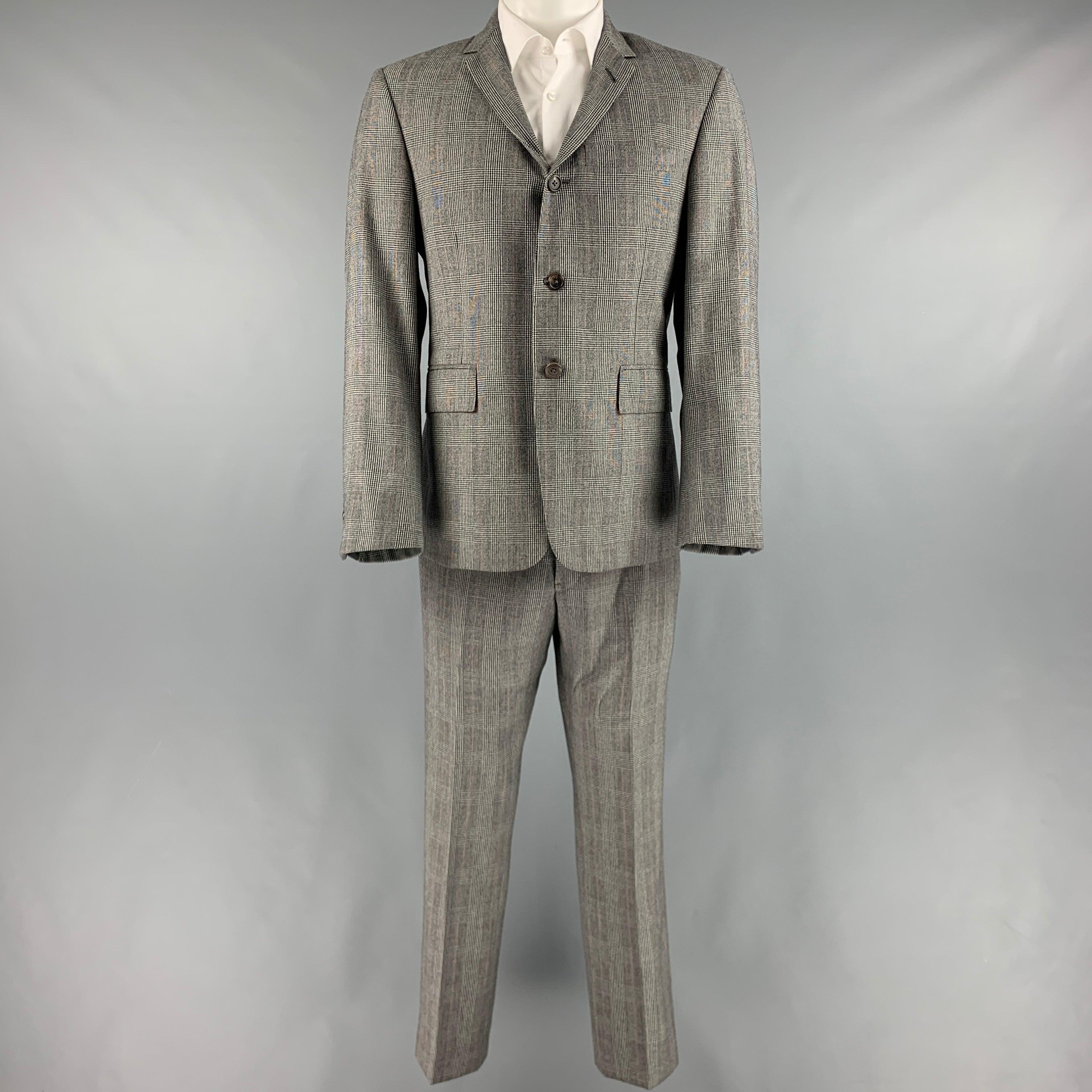 THOM BROWNE for BARNEY'S suit
in a black and white wool with a full liner and includes a single breasted, three button sport coat with notch lapel and matching flat front trousers.
Handmade in USA.Excellent Pre-Owned Condition. 

Marked:   2