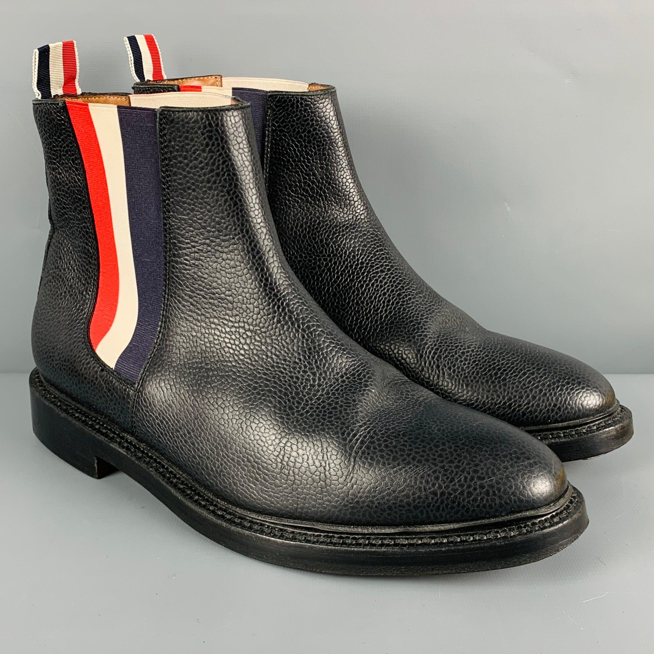 THOM BROWNE
boots in a black leather fabric featuring a Chelsea ankle style with red & white elastic panels, pebble grain texture, and a pull on closure. Made in Italy.Very Good Pre-Owned Condition. 

Marked:   EU 42 

Measurements: 
  Length: 11.75