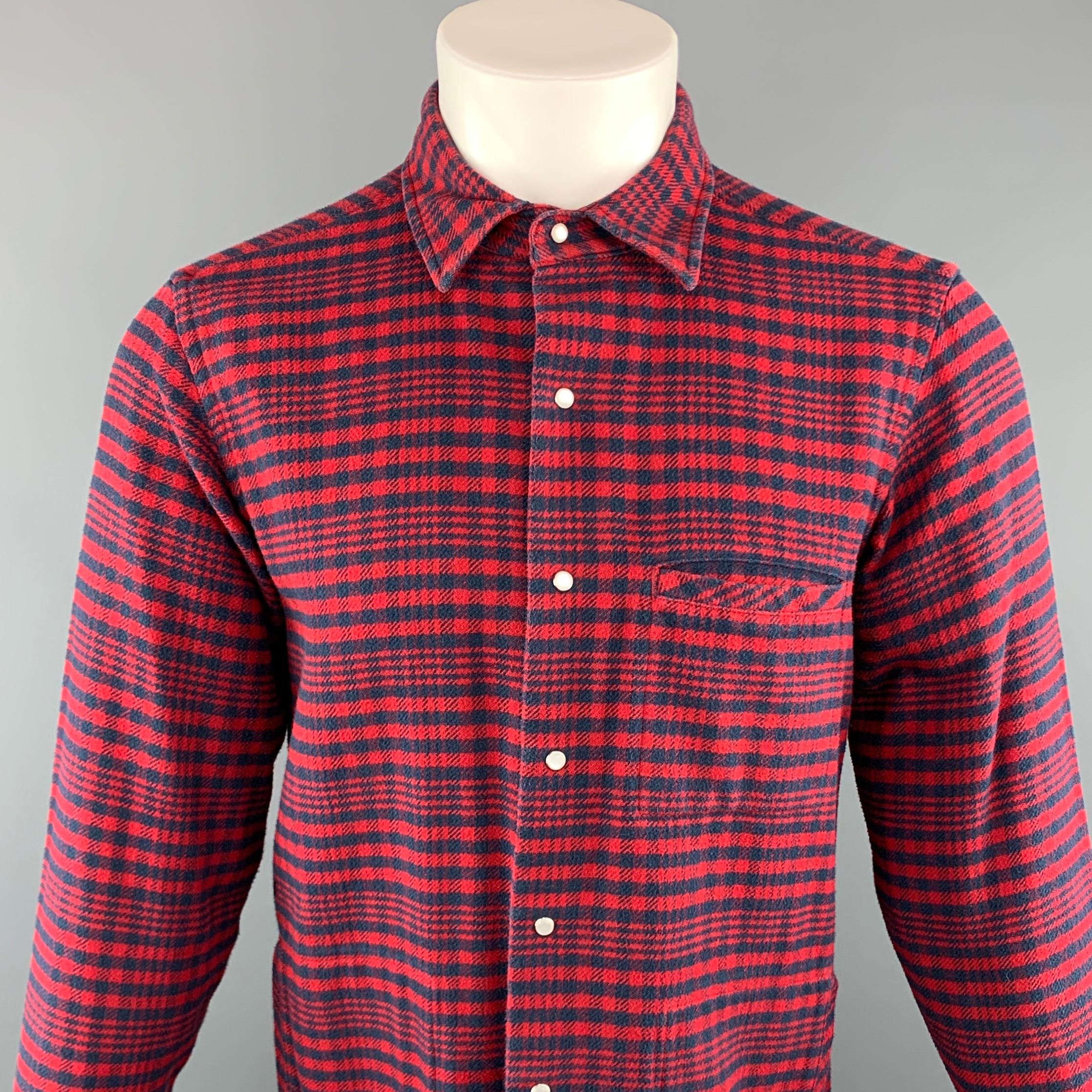 THOM BROWNE long sleeve shirt comes in a red and navy plaid cotton featuring a button up style, snap closure, front patch pocket, and a spread collar. Made in USA.
 
Excellent Pre-Owned Condition.
Marked: 2
 
Measurements:
 
Shoulder: 17 in.
Chest: