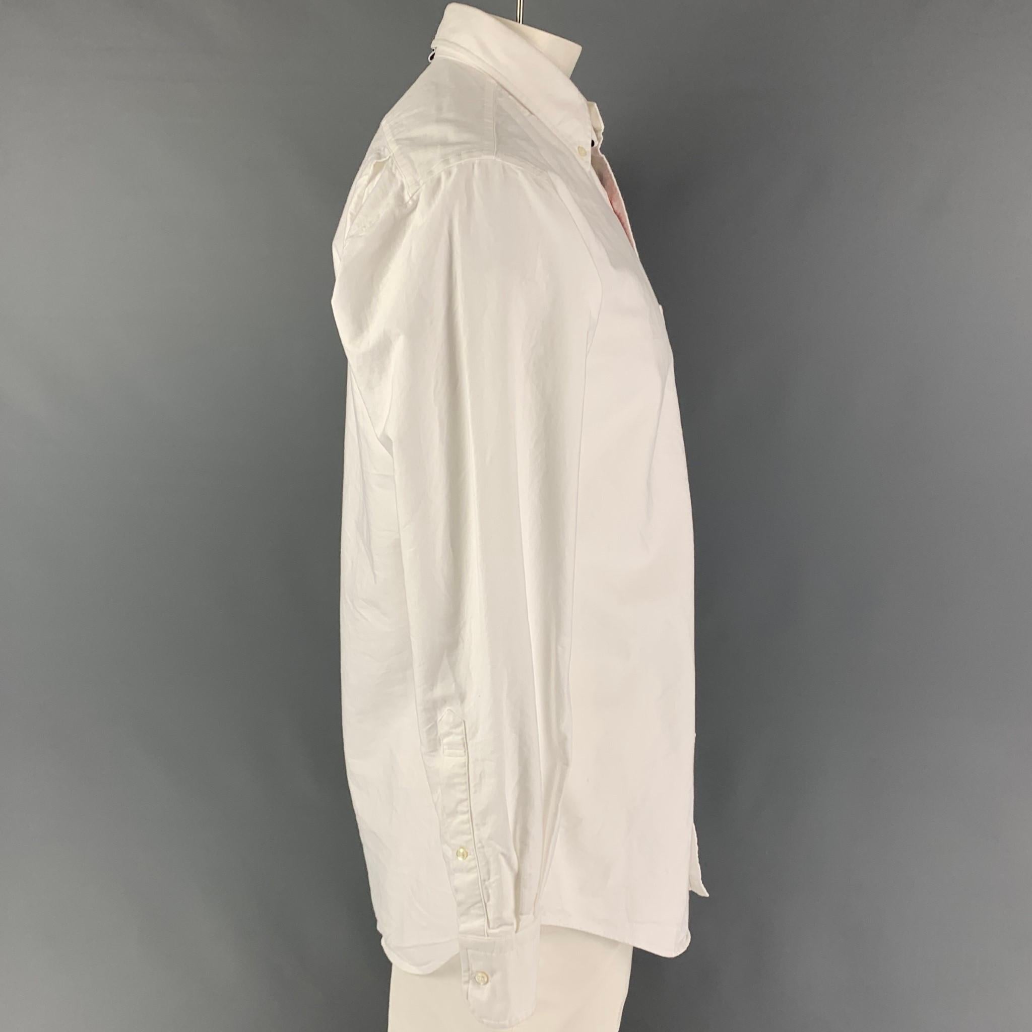 THOM BROWNE long sleeve shirt comes in white cotton featuring a striped trim, button down collar, patch pocket, and a button up closure. Made in Italy.

Good Pre-Owned Condition. Moderate discoloration at front. As-Is.
Marked: