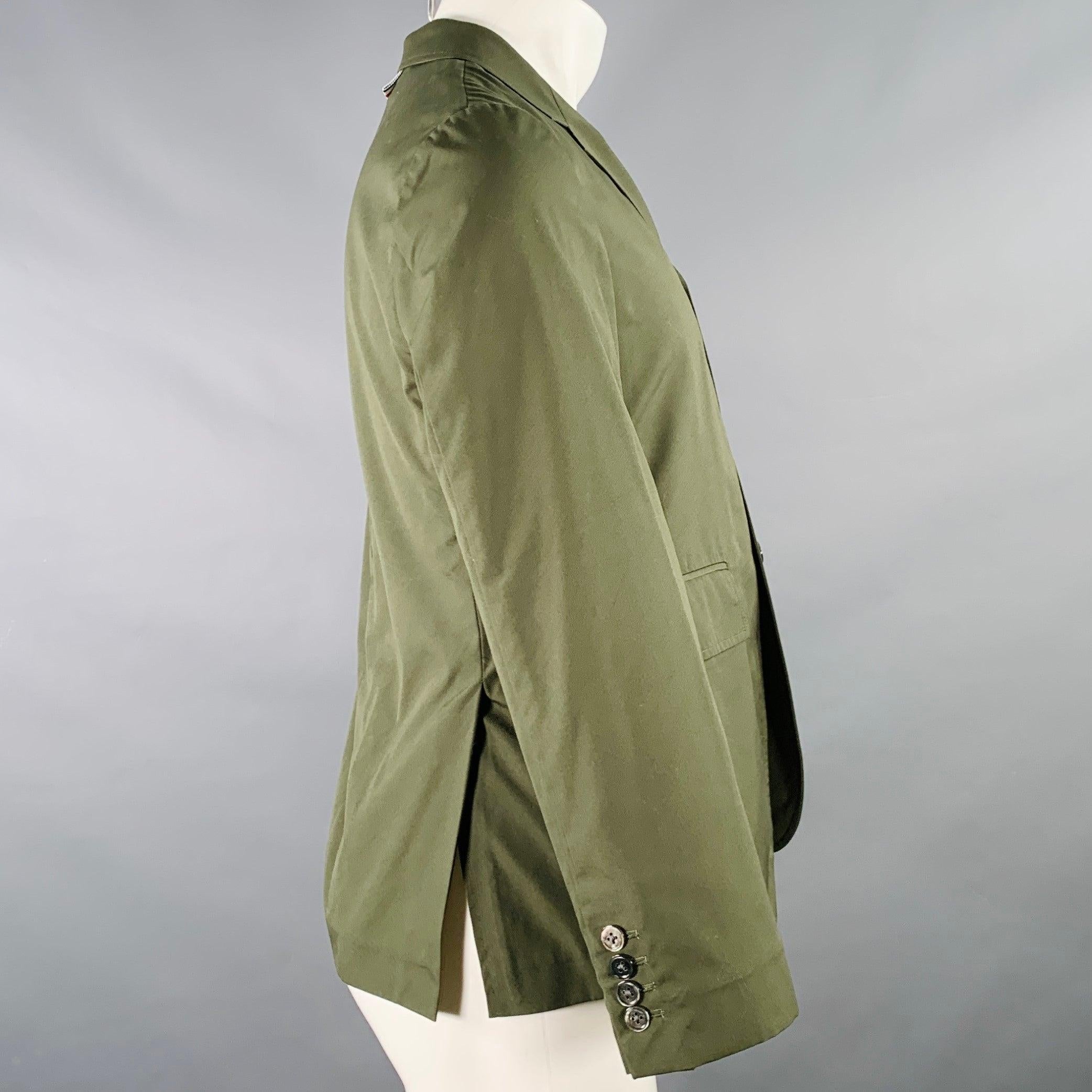 THOM BROWNE jacket
in an olive green woven fabric (feels like cotton) featuring a notch lapel, double vented back, and three button closure. Made in Japan.Excellent Pre-Owned Condition. 

Marked:   0 

Measurements: 
 
Shoulder: 16 inches Chest: 38
