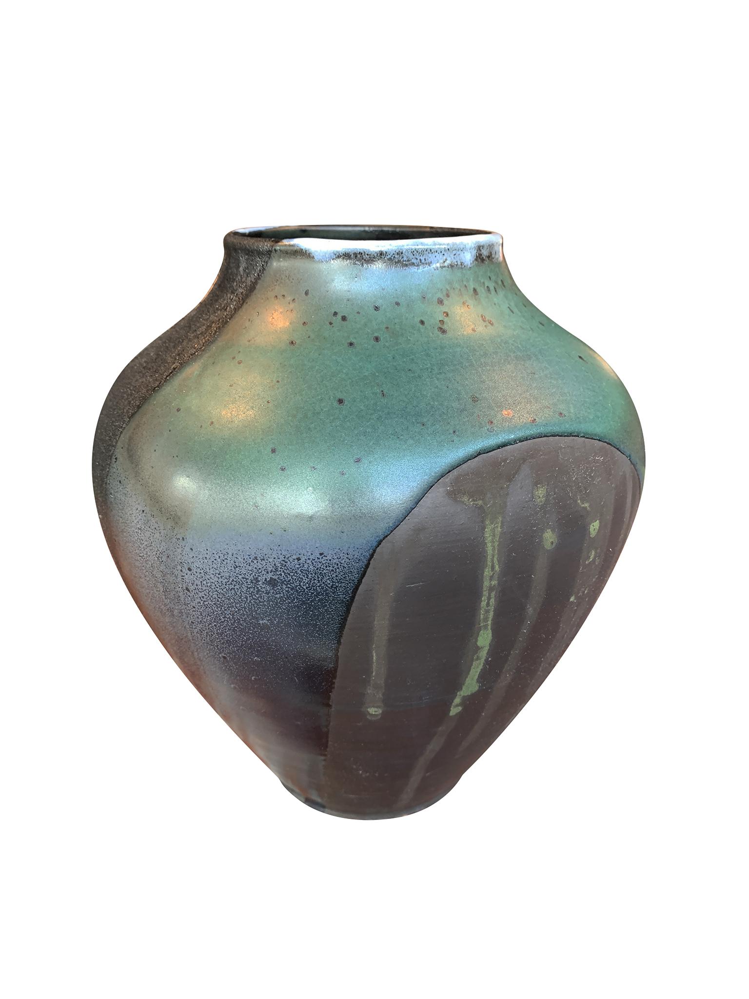 A Thom Lussier ceramic urn exclusively made for Cafiero Select. The vase is one of a series of vessels on which the artist applies a mixture of glazing techniques to create richly textured surfaces. Here, he combines metallic glazing with a matte