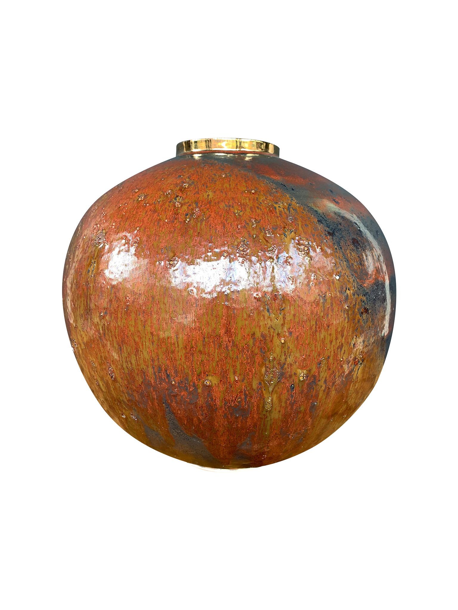 From Thom Lussier's Golden Patina Collection - a series of ceramic vessels with rich, colorful surfaces that evoke both terrestrial and otherworldly terrain. This vessel is spherical in form with a lipped opening rimmed in a gold finish.

White