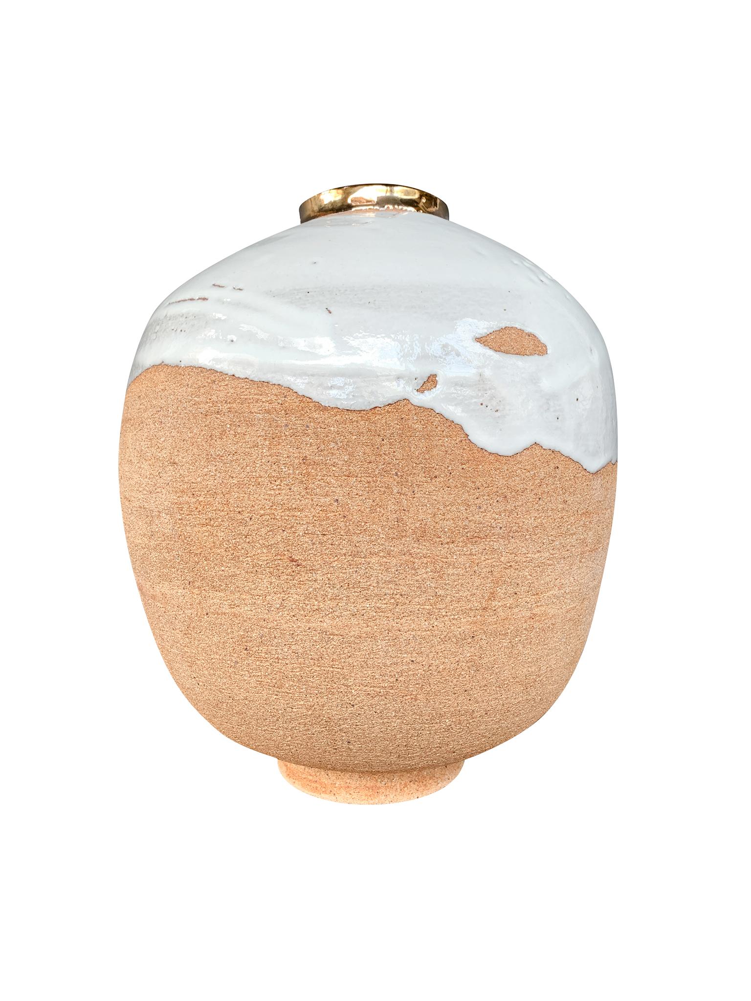 From Thom Lussier's Golden Patina Collection - a series of ceramic vessels with rich, colorful surfaces that evoke both terrestrial and otherworldly terrain. #5 is round in form with a lipped opening rimmed in a gold finish. Its top half has a white