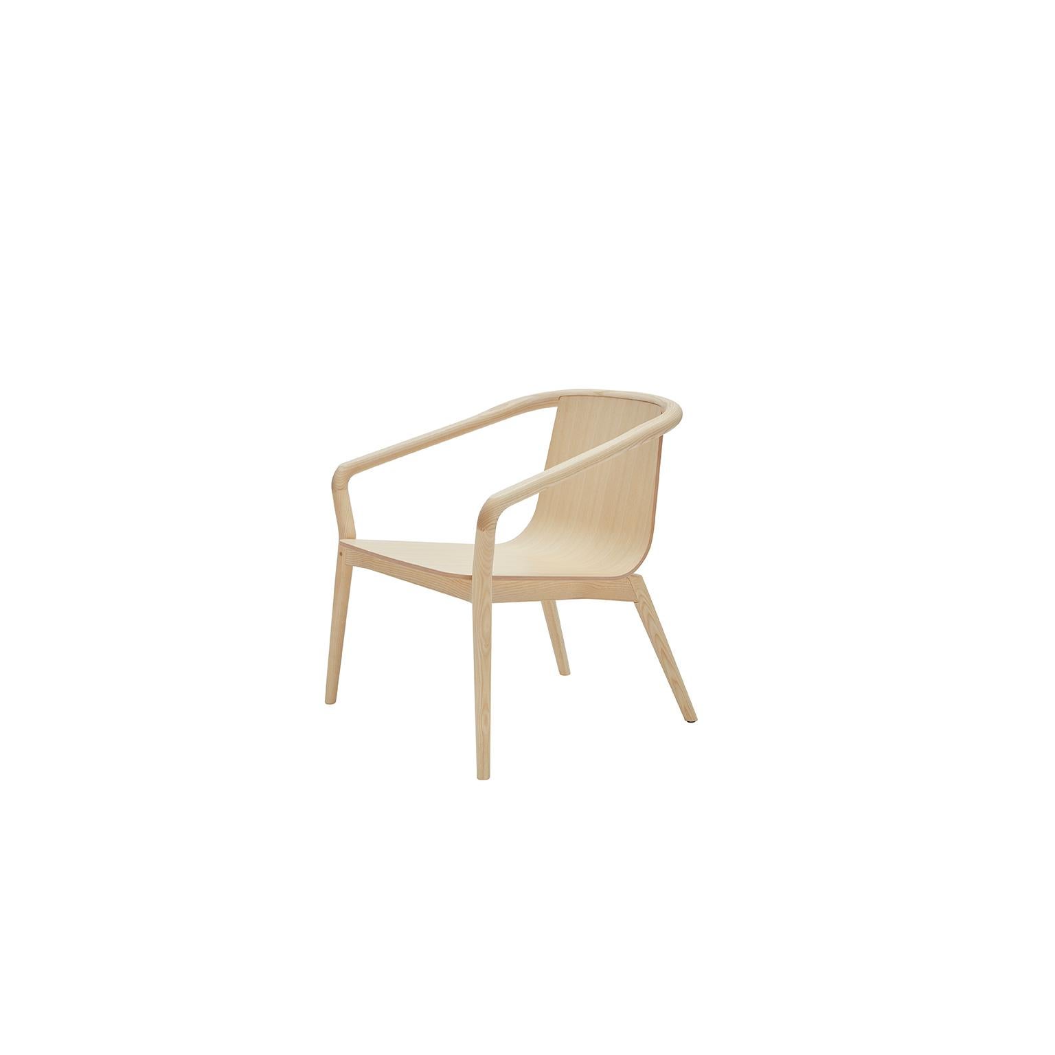 The Thomas armchair is derived from the same design elements as its namesake dining chair, featuring a formed plywood shell suspended in a solid ash frame with the distinctive carved armrest detail. The proportions are modest, ensuring suitability