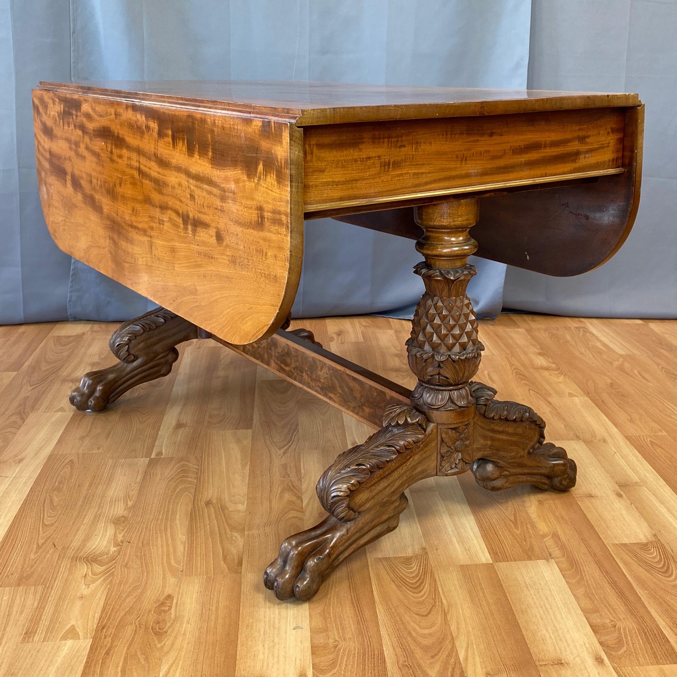 An extraordinary well-crafted and uncommon early 1820s American Classical mahogany drop-leaf dining table with pineapple and paw base by New York master cabinetmaker Thomas Astens.

Strikingly handsome mahogany top, leaves, and apron with