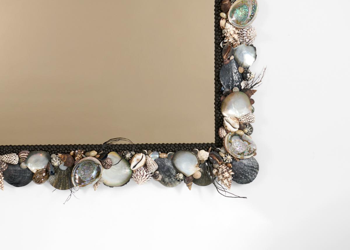A decorative mirror by the French artisan Thomas Boog, this remarkable, delicately crafted round piece of coquillage is made up of a variety species. The mirror embedded at the center brings an air of functionality to this otherwise whimsical piece.