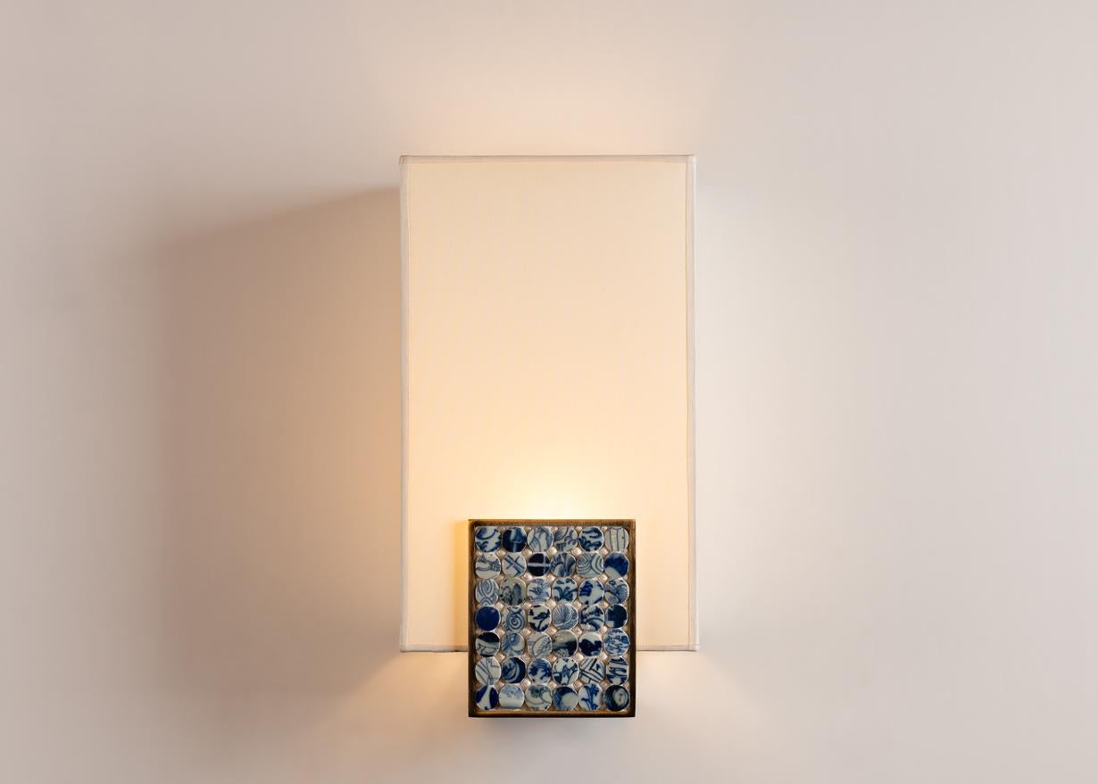 The sconce's base is made of blue mother of pearl and patinated bronze, while the shade is silk. 'Pastilles' was designed in 2012 by Swiss born, Paris based artist Thomas Boog, known for his innovative use of the traditional shell art coquillage.