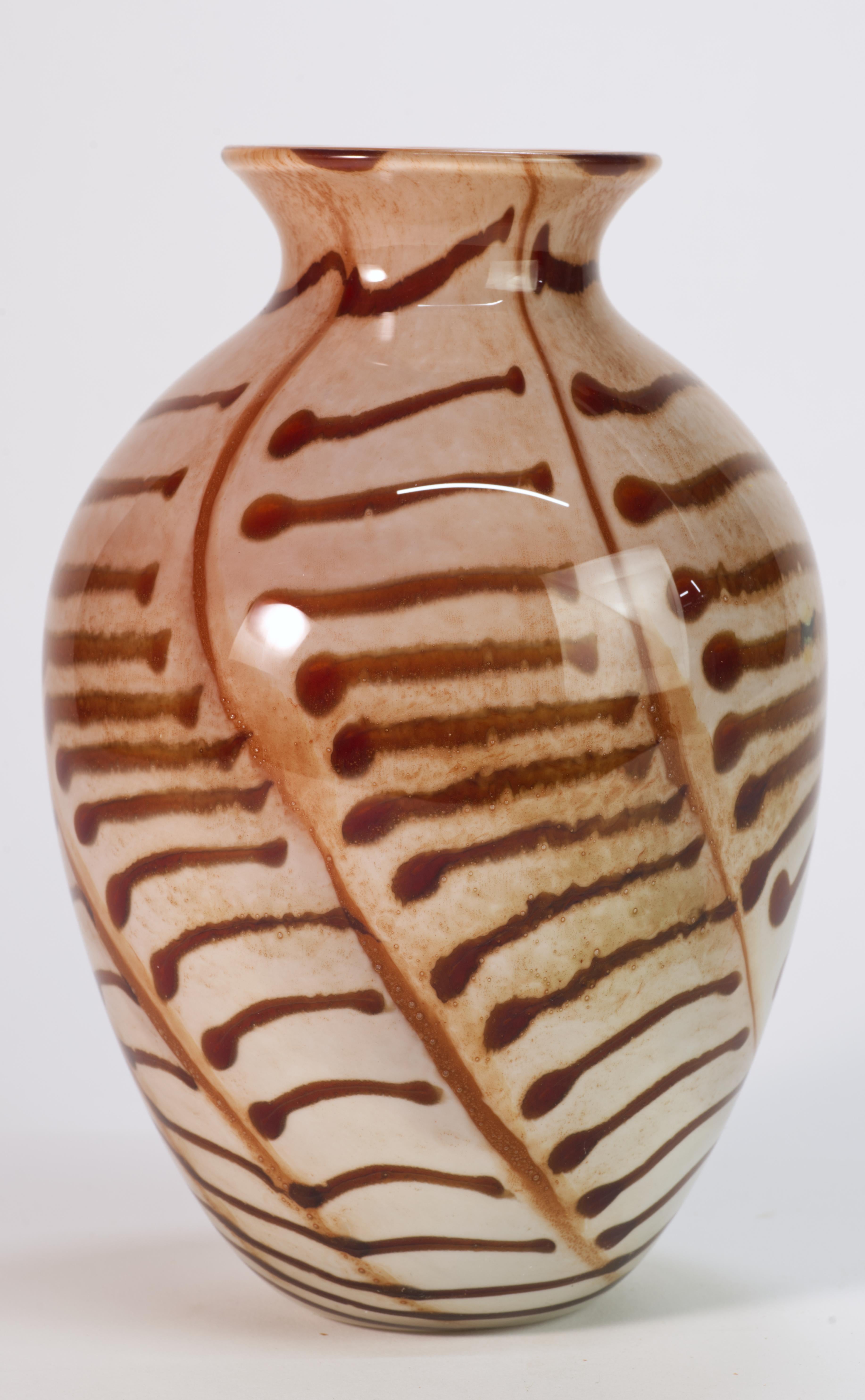  Sculptural Organic Modern vase was hand blown with thin layer of red glass underlying the two-toned fused glass. The abstract, graphic pattern of dark red, almost burgundy colored fused glass on light beige background is swirling around the curves