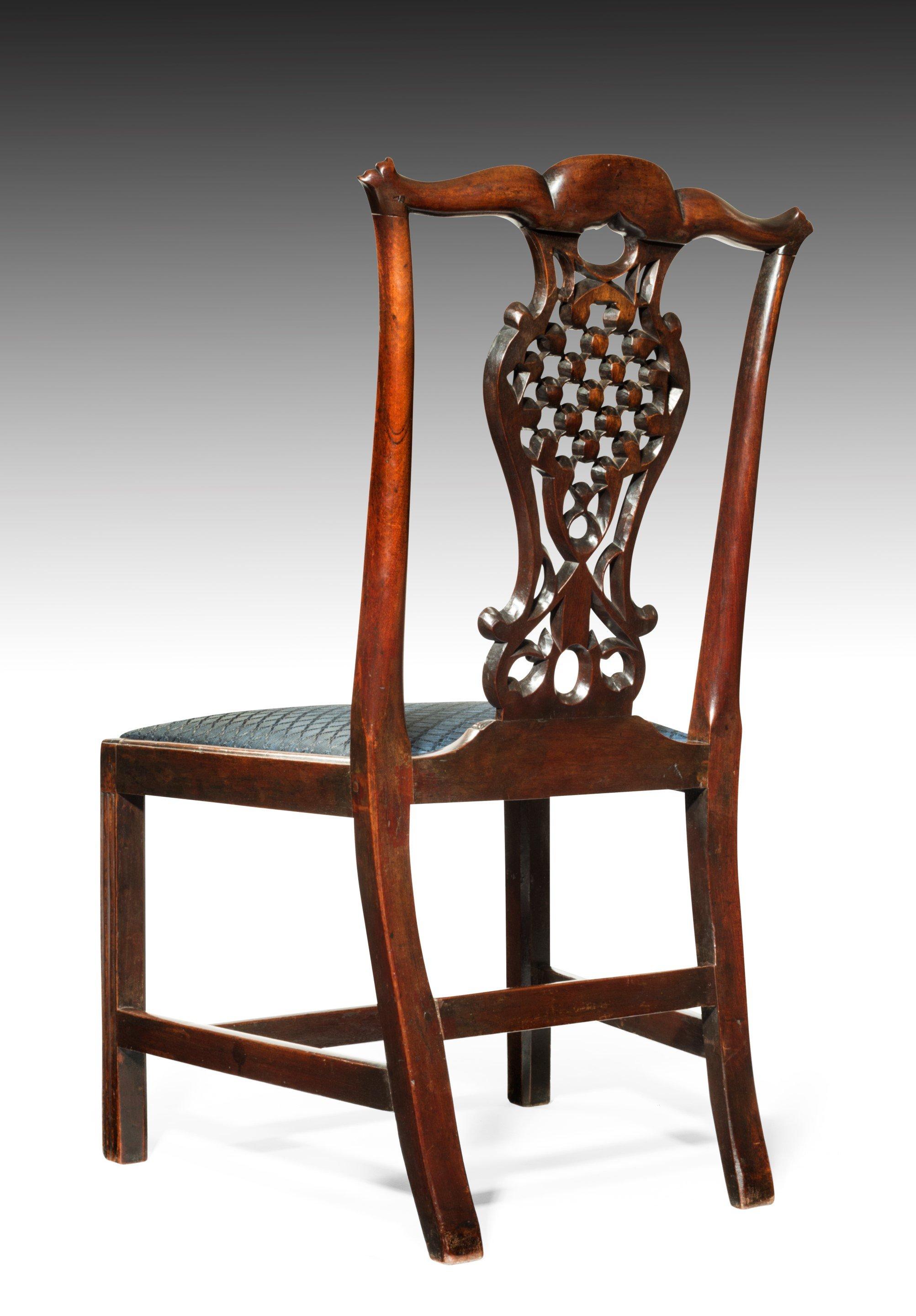 An exceptional pair of rare George III period mahogany side chairs, with a Chinese lattice back splat, after the designs of Robert Mainwaring. The carving is well drawn and finely executed, with the back view of the back-splat every bit as