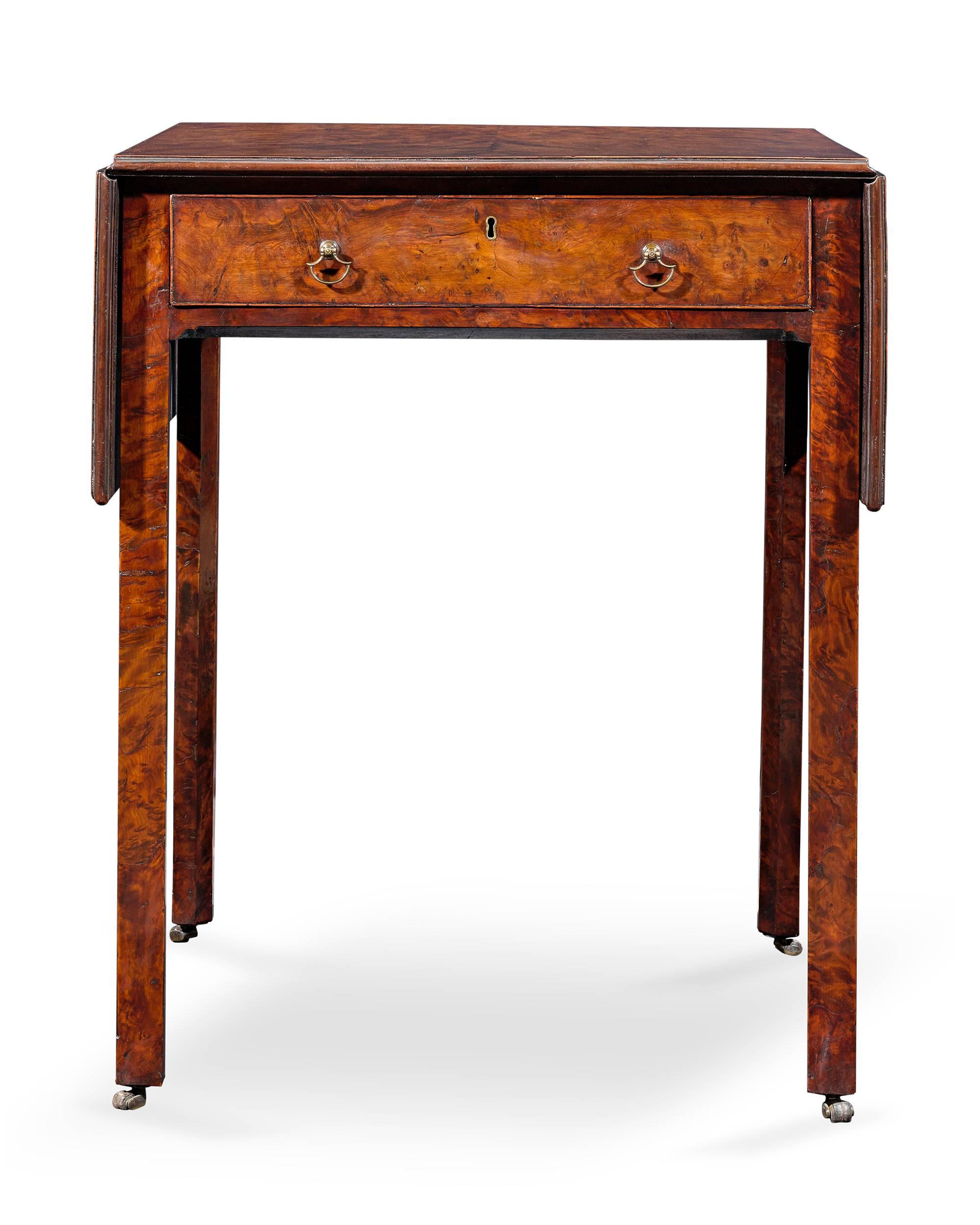 Bearing the characteristics of the legendary Thomas Chippendale is this rare George II-period Pembroke table. Veneered entirely in burr yew wood, this table is a sight to behold. With its balanced design, beautiful proportions, rich patina and
