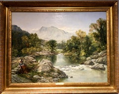 Extensive River landscape in Wales with a lady and her dog seated by the river