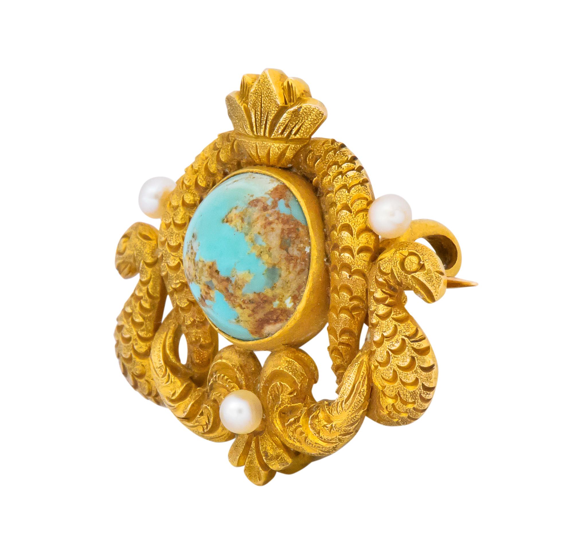 Centering a round cabochon turquoise, measuring approximately 9.0 mm, with visible matrix and greenish blue

Accented with tiny seed pearls, very well matched

With highly detailed and textured gold serpent and floral motif

Pin stem and hook for a