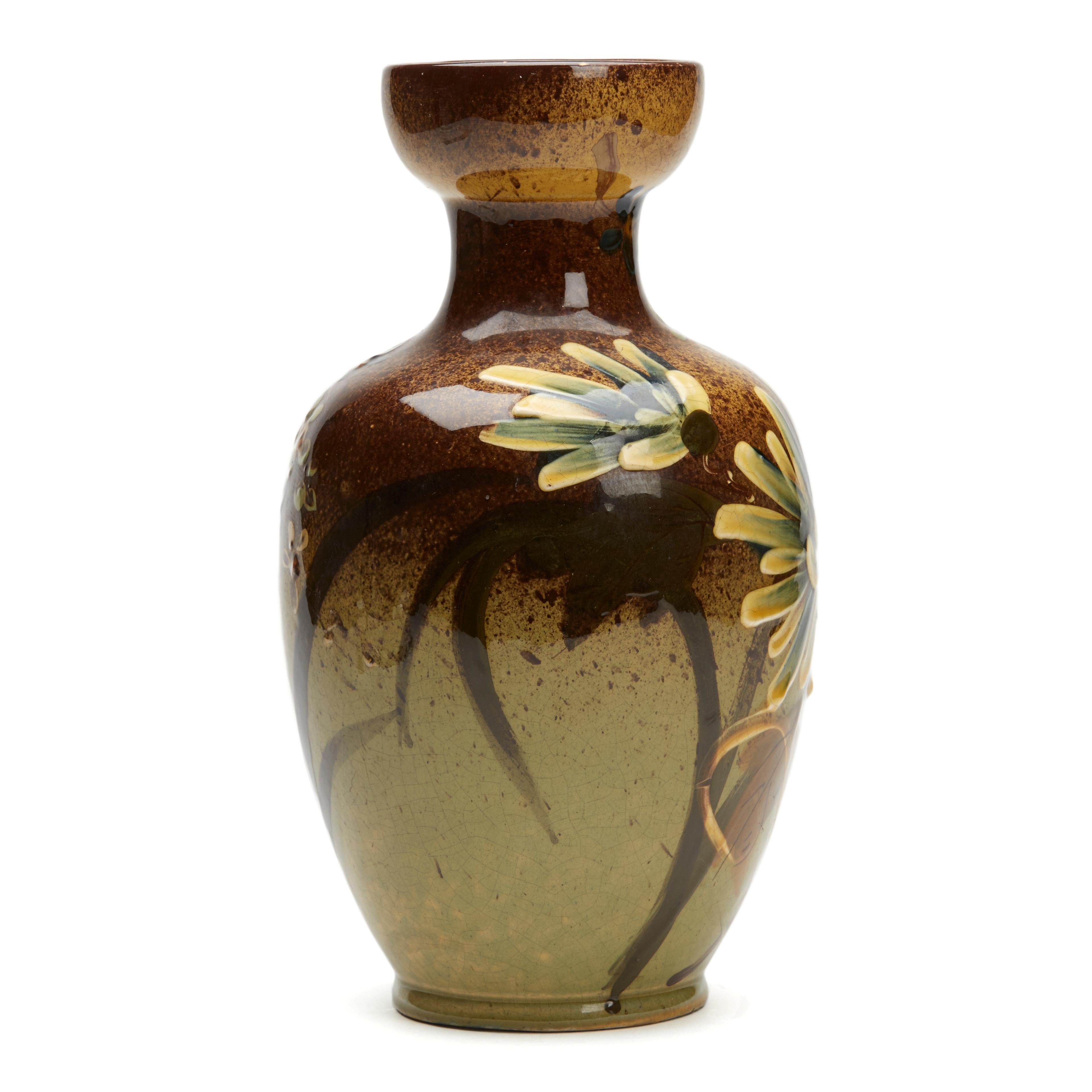 A stunning antique Thomas Forester hand painted art pottery vase decorated with large flowering blooms dating from around 1890. The lightly potted earthenware vase stands on a narrow round unglazed foot with slightly recessed base with a bulbous
