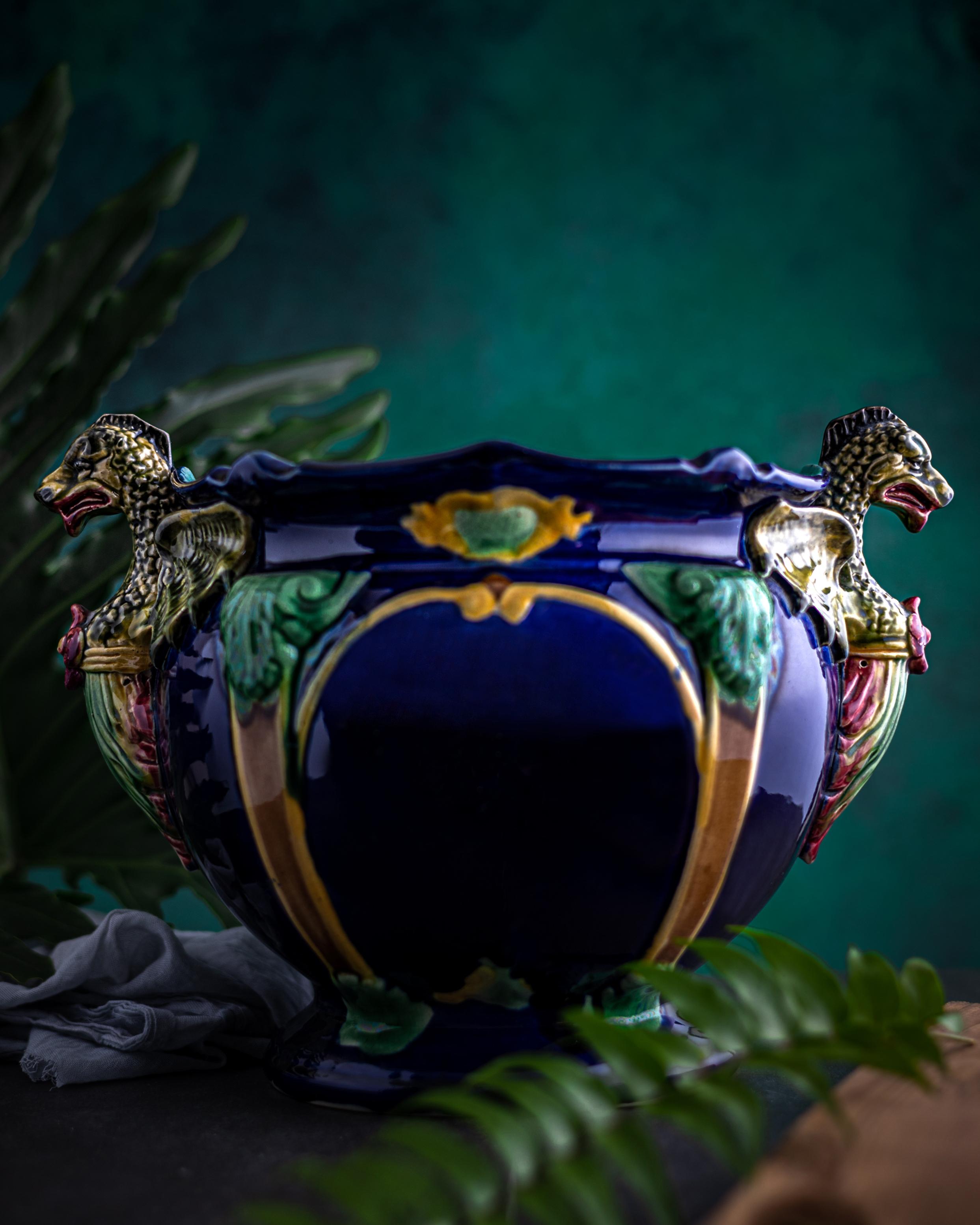 A cobalt blue Majolica jardiniere made by Thomas Forester & Sons circa 1888 in the Revivalist style. The jardiniere features Gothic-style dragon handles and Renaissance-style architectural designs.

Revivalist styles became quite popular during