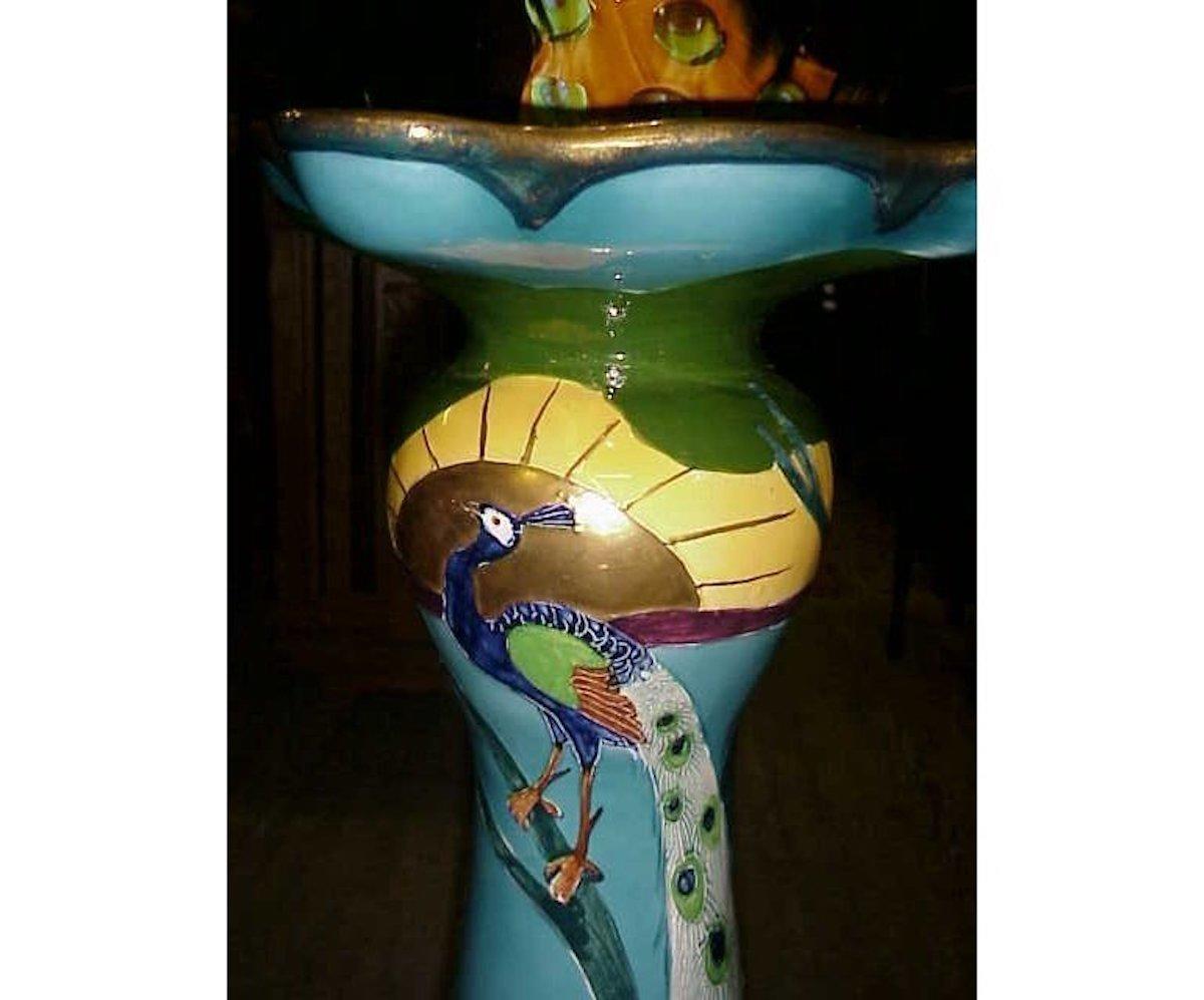 Thomas Forrester Phoenix Works, factory Longton. England. 
An English Arts & Crafts jardiniere and stand in different colorways, both with Peacock decoration and the setting sun. The base of the jardiniere it is signed Suez, and to the side of the