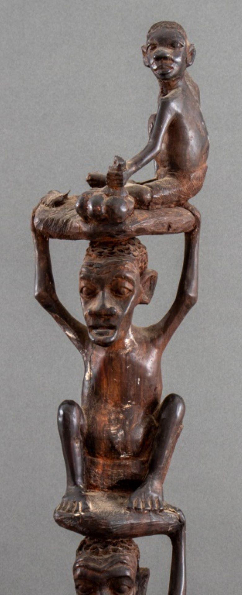 Thomas Hamis (African, XX), likely Makonde, hand-carved wood tree of life sculpture comprised of stacked ancestor figures, signed to underside.