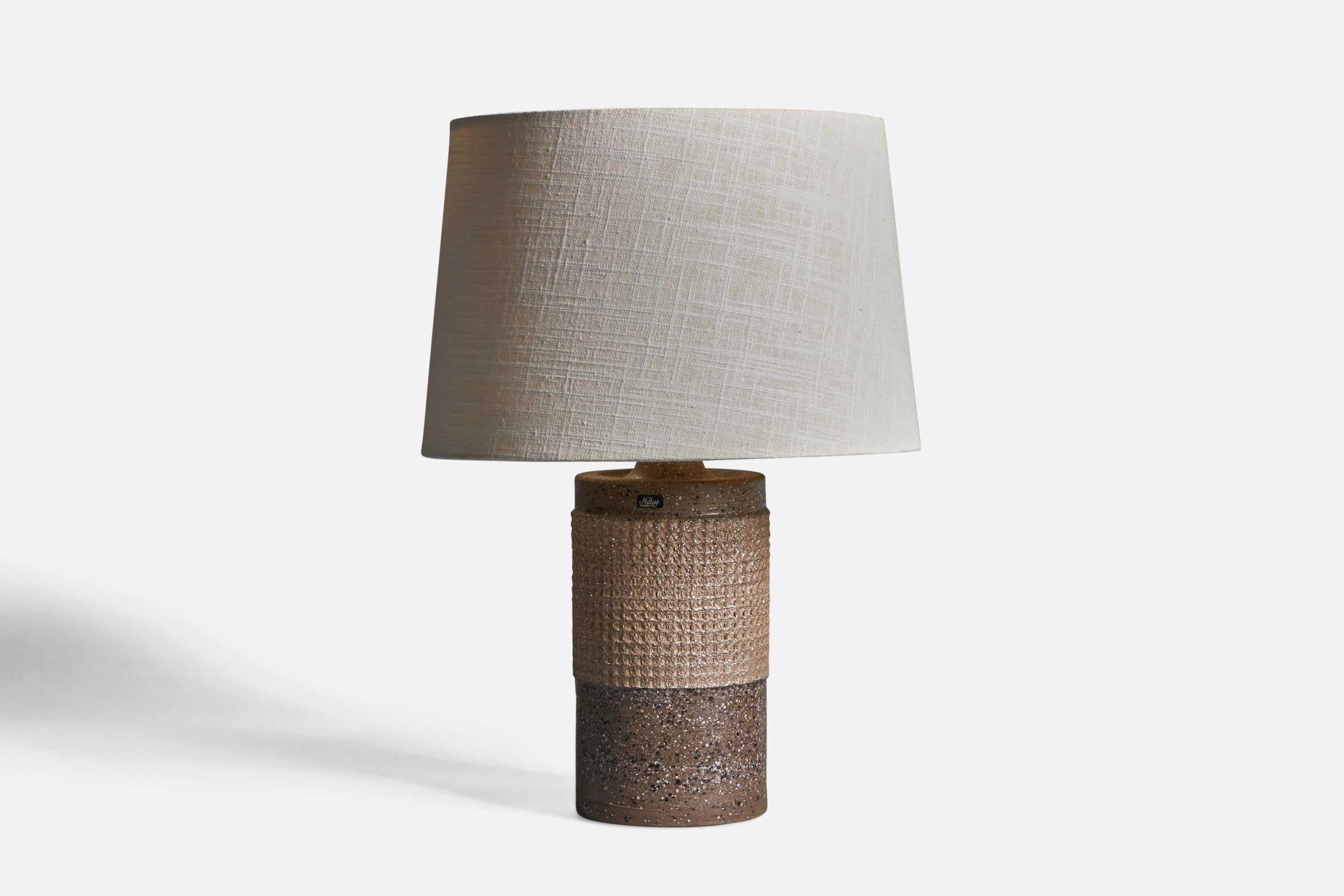 A incised grey stoneware table lamp, designed by Thomas Hellström and produced by Nittsjö, Sweden, c. 1950s.

Overall Dimensions (inches): 16.75