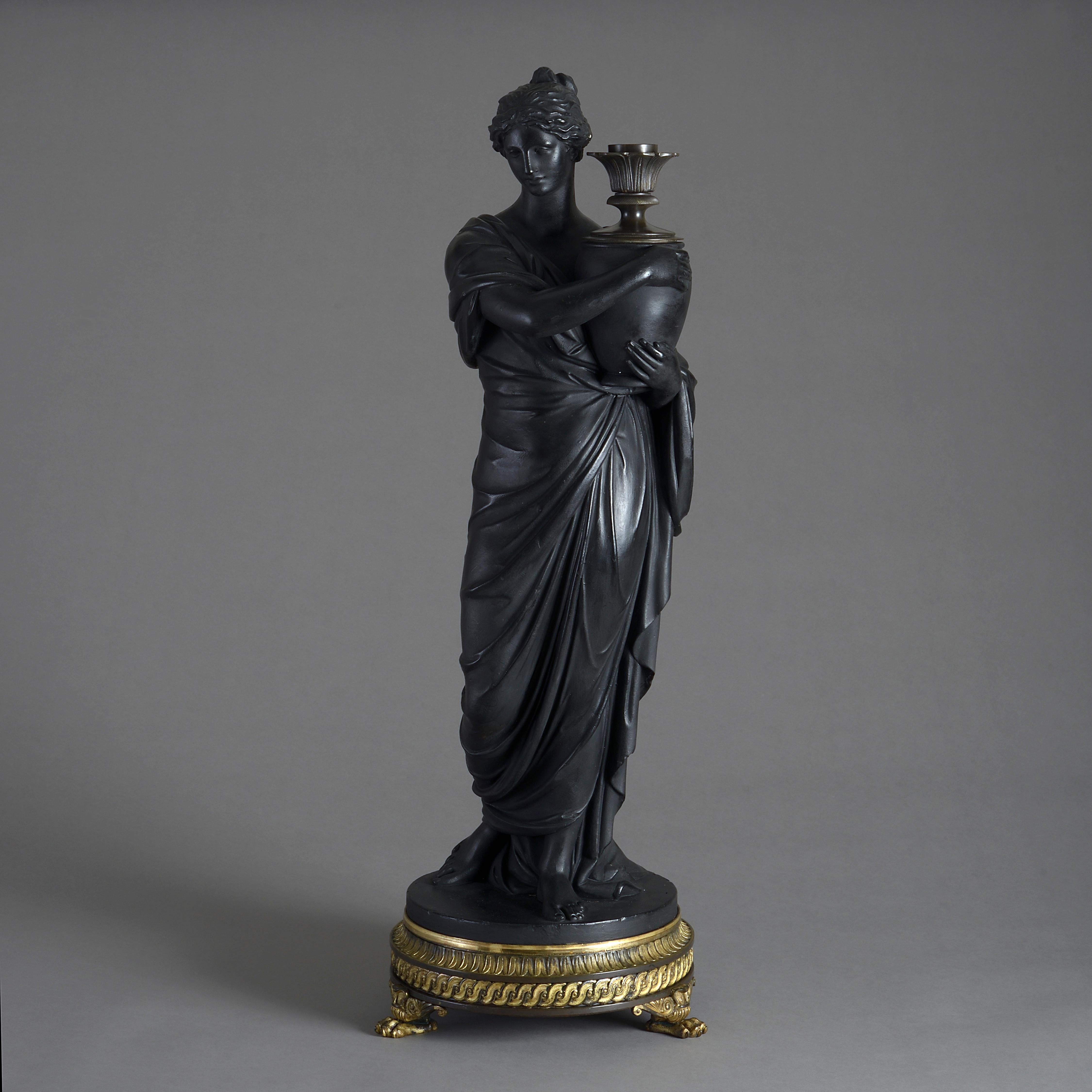A fine regency bronzed plaster figure of a vestal bearing a lamp by Thomas hopper, circa 1807.

Signed H. HOPPER LONDON JULY 6 1807.

With its original bronze lamp fitting and fine bronze and ormolu base with stiff leaf and guilloche mouldings