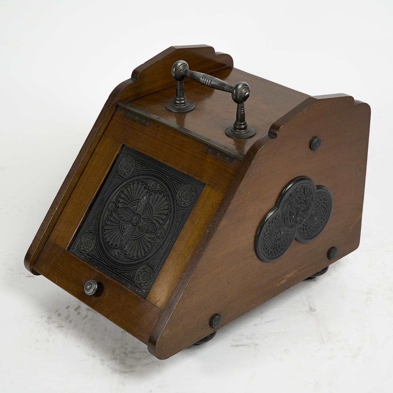 Thomas Jeckyll for Barnard Bishop and Barnard. A rare Aesthetic Anglo-Japanese Walnut coal box with Japanese style circular devises to the front lift up flap, and treble linked circular devises to each side are identical to the circular devices