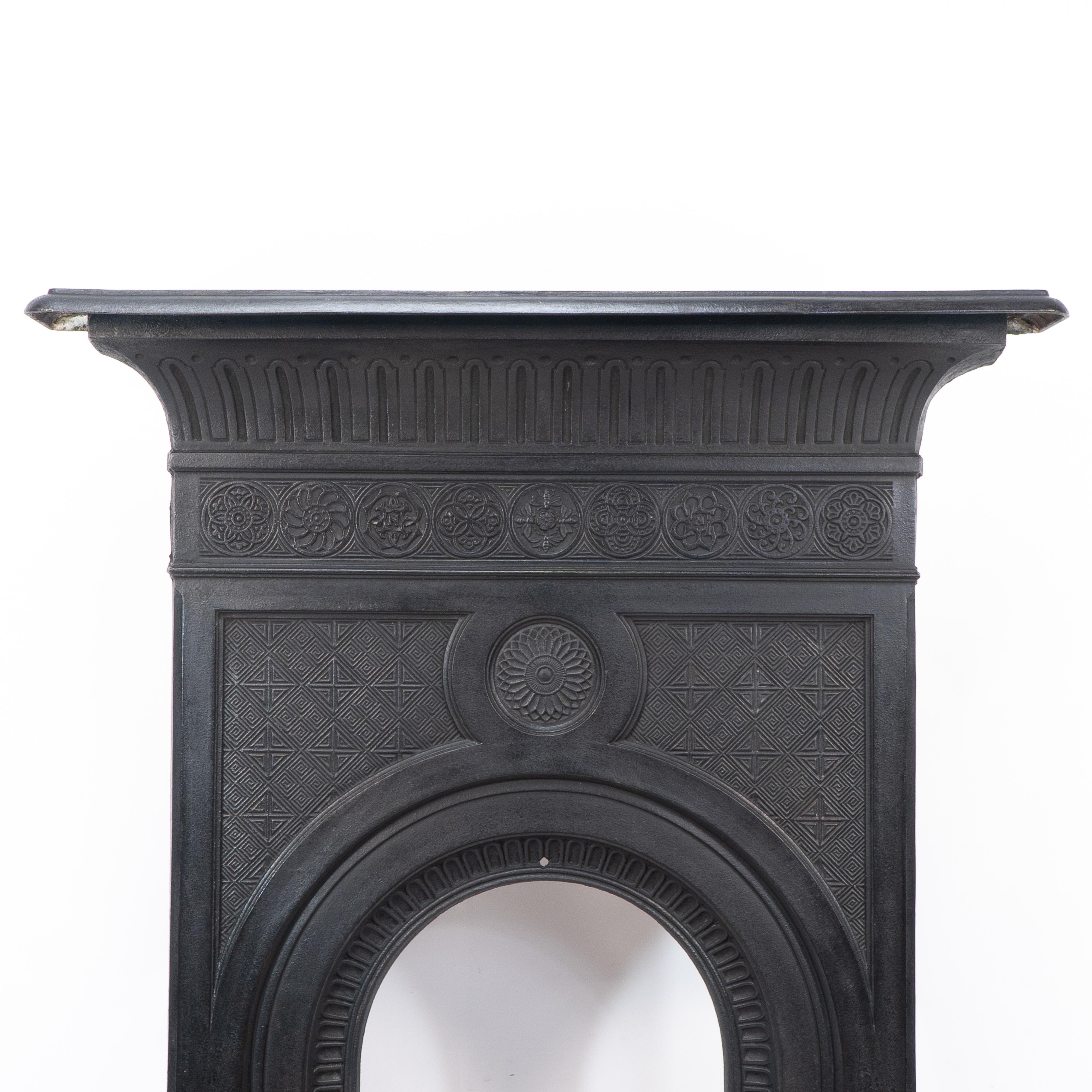 Thomas Jeckyll for Barnard Bishop and Barnard. A rare Aesthetic Movement fireplace with curvaceous mantle with gadrooned and dot details and a row of Japanese floral Insignias the centre one decorated with Barnard, Bishop and Barnards trademark four