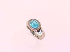 Ring in Platinum with 1 Paraiba Tourmaline Cabouchon Oval 9x7mm and 26 Diamonds
