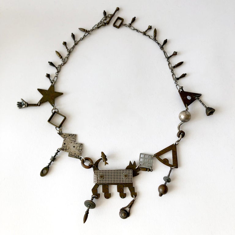 Kinetic cabinet of curiosities handmade necklace created by Thomas Mann.  Necklace measures 23