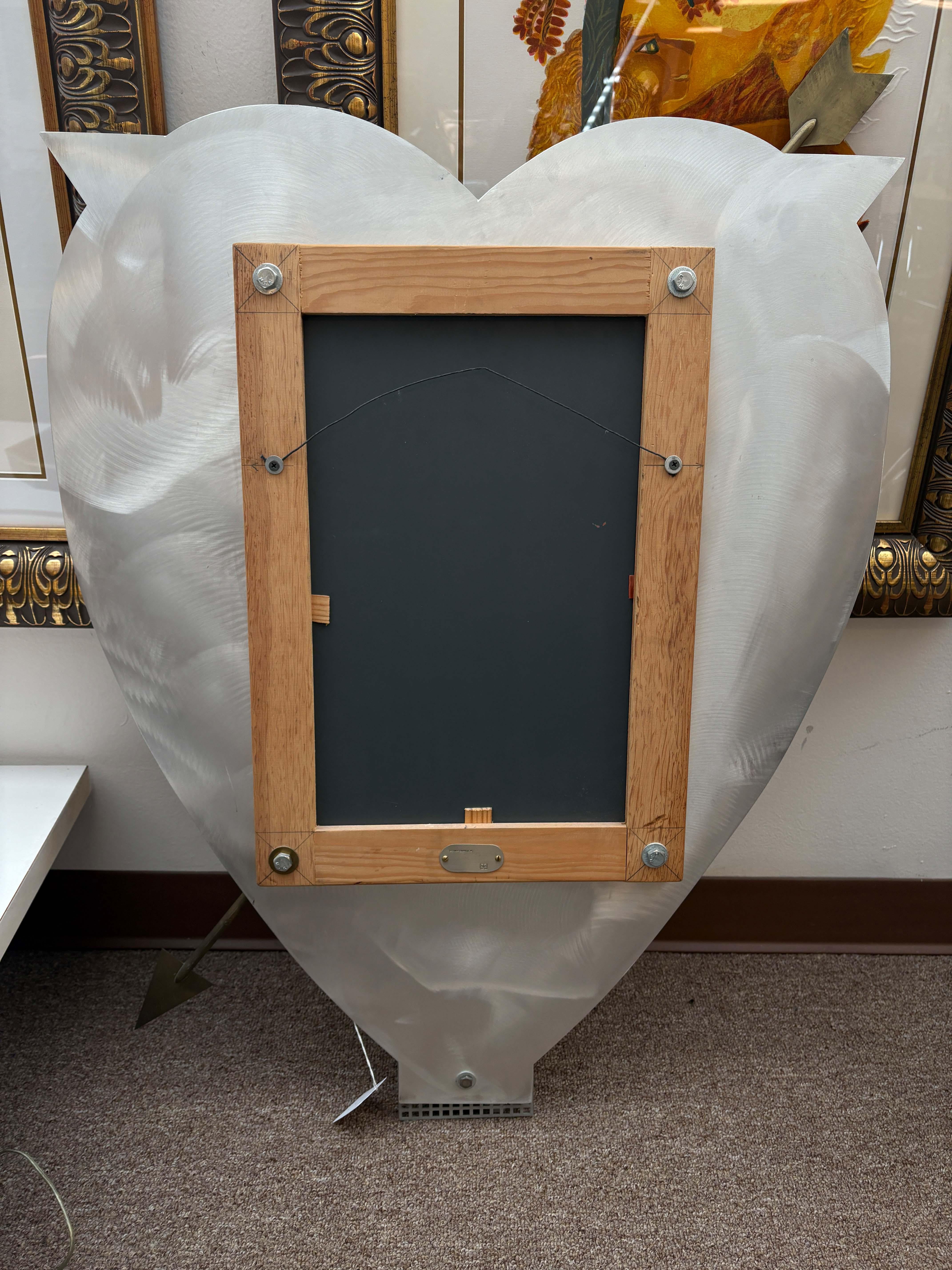 A Thomas Mann Techno-Romantic arrow through the heart accent mirror. Thomas Mann is an American metal artist based in Louisiana who has been creating and making for over 40 years. His work is vast and explores many themes and various mediums of