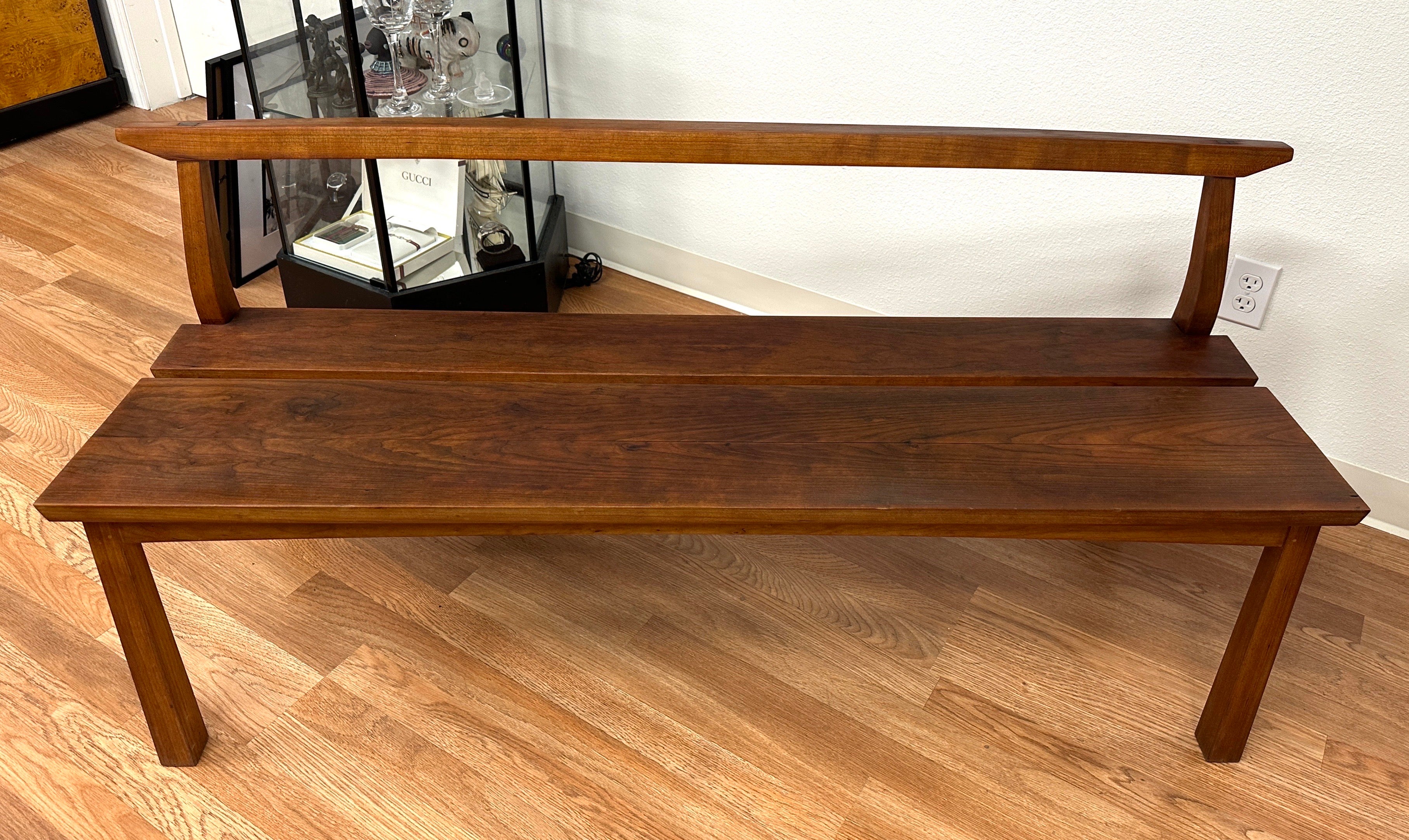 Beautiful hand made bench by Thomas Moser of Maine. I believe it's called the Edo bench. Crafted of solid cherry wood, the piece was nicely taken care of and has a lovely patina. It's been darkened by some use on the seat. In good condition with