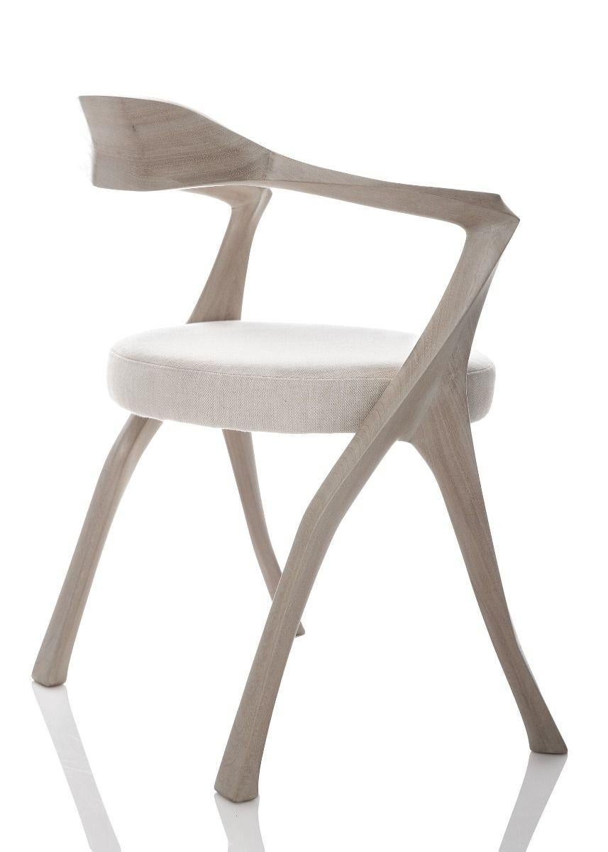 Designed as a companion to the Homage table, this chair works well with a wide variety of contemporary styles. It is a contemporary interpretation of a classic chair architecture featuring fine carving, a minimalist spirit, and extraordinary