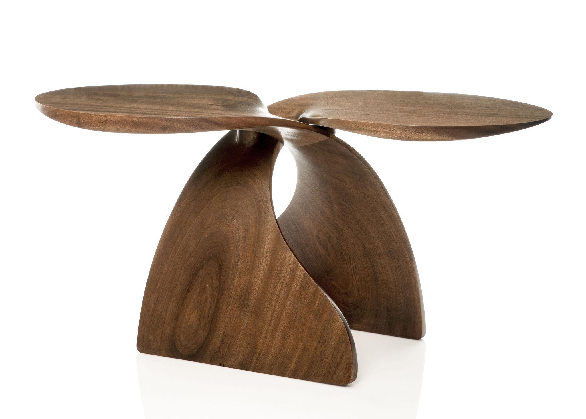 This contemporary table combines the clearly organic shape of the hand carved sweeping base elements, with the contemporary, geometric shape of the tops. Made up of two of identical sapele wood carvings, it has a playful rhythm like a pair of fish,