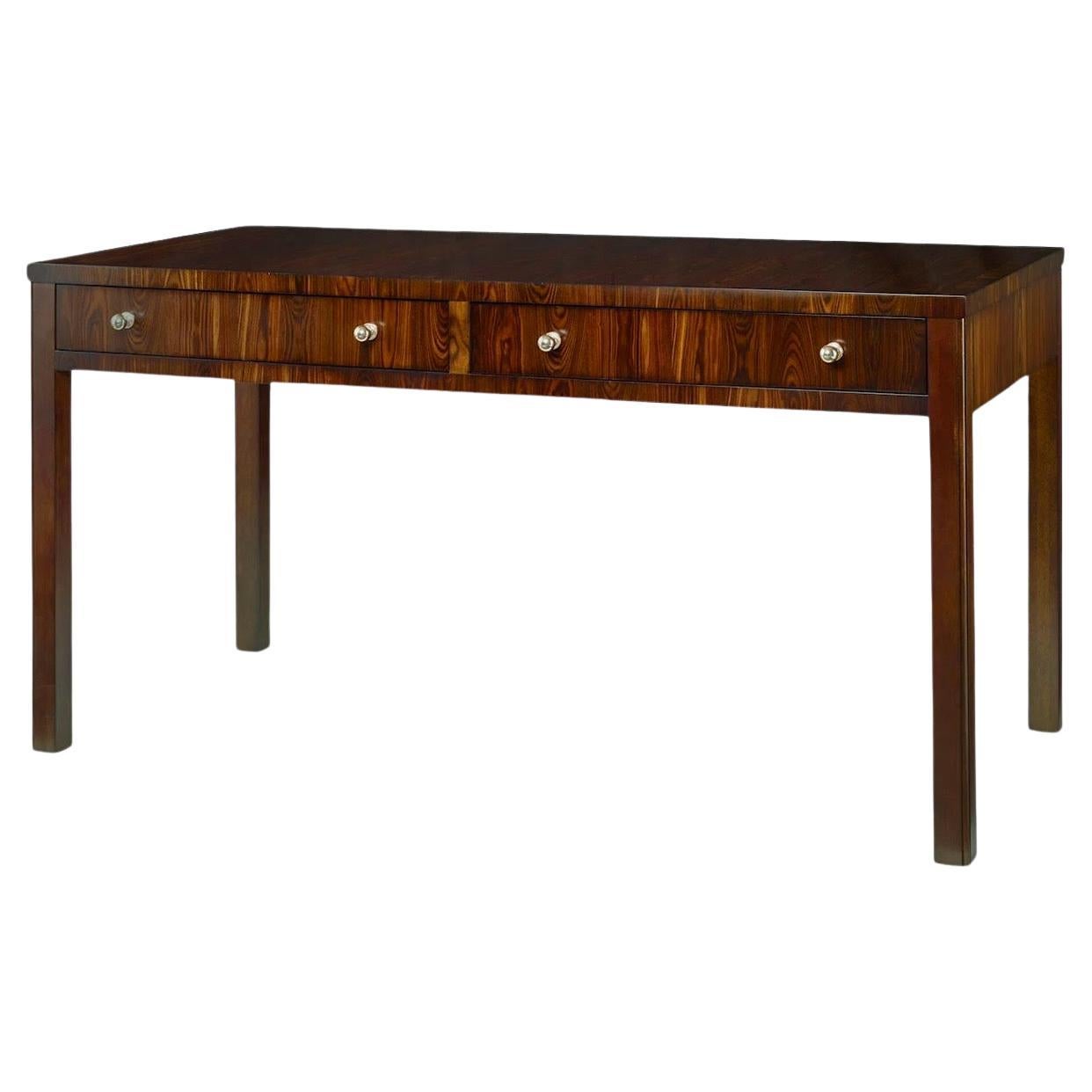 This is a beautiful desk designed by Thomas O’Brien for Century. It is a compilation of kingwood veneers over mahogany, which gives it a rosewood effect. It has two drawers and is marked. 

My shipping is for the Continental US only and can run two